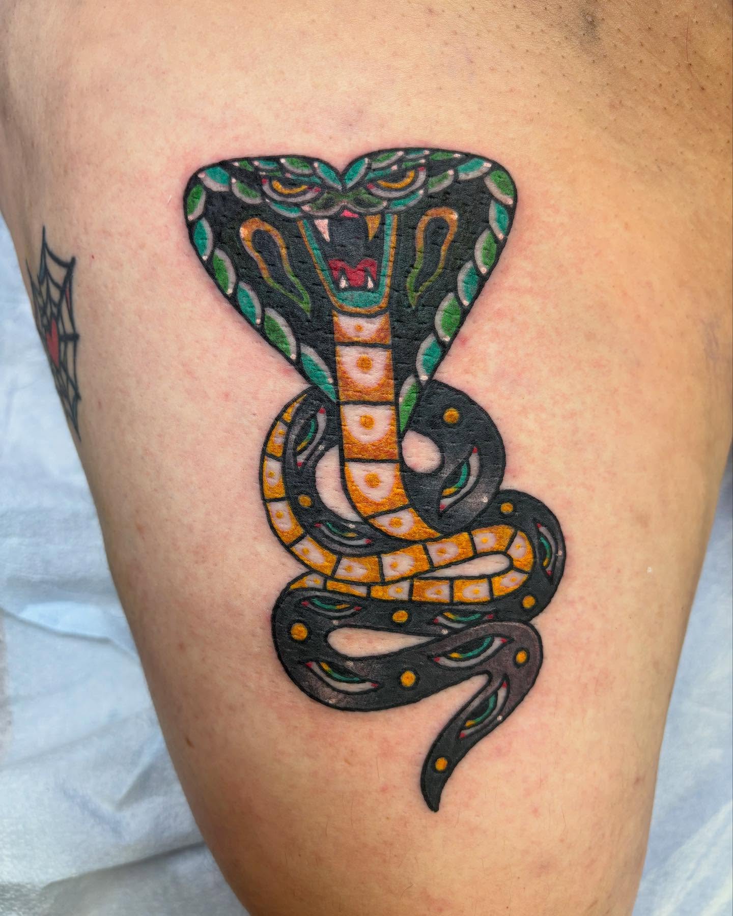 Snake American traditional tattoo on the thigh by Dave