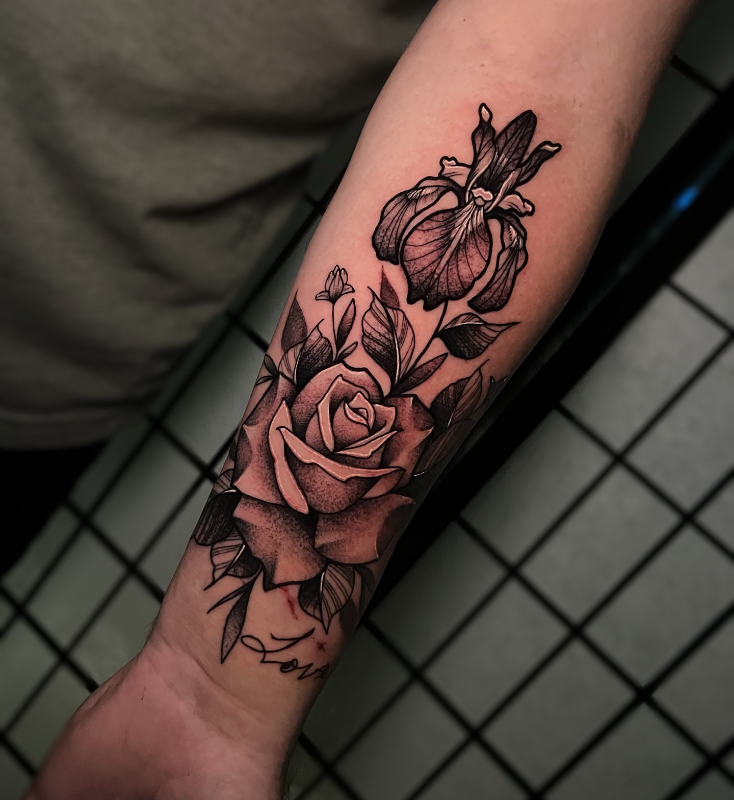 Rose and orchid realism tattoo on the forearm by Tattoo Artist