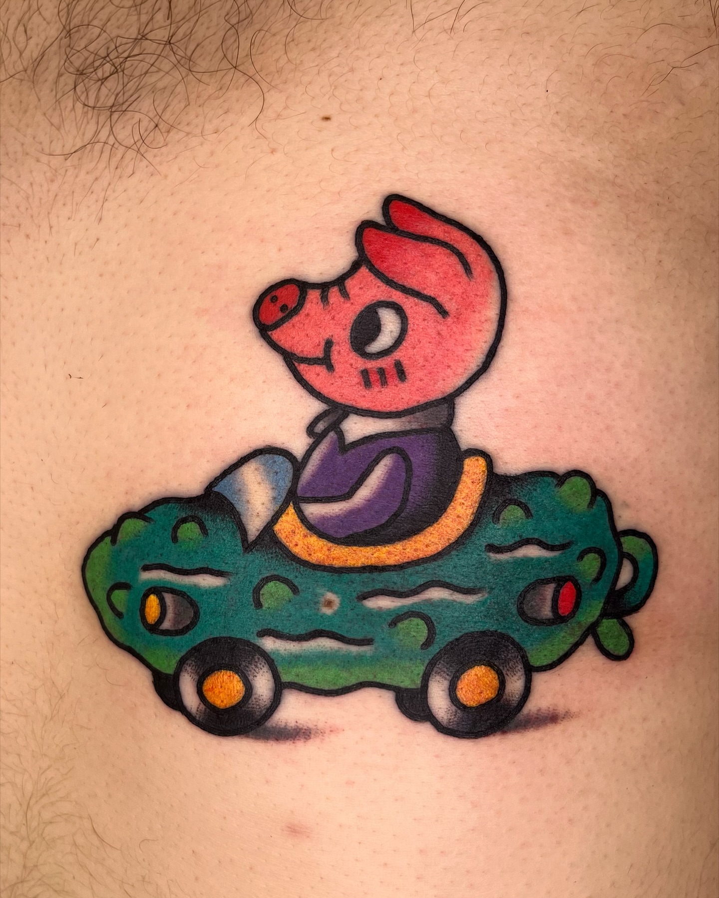 Pig driving car American traditional tattoo on the thigh by Robyn Fricke