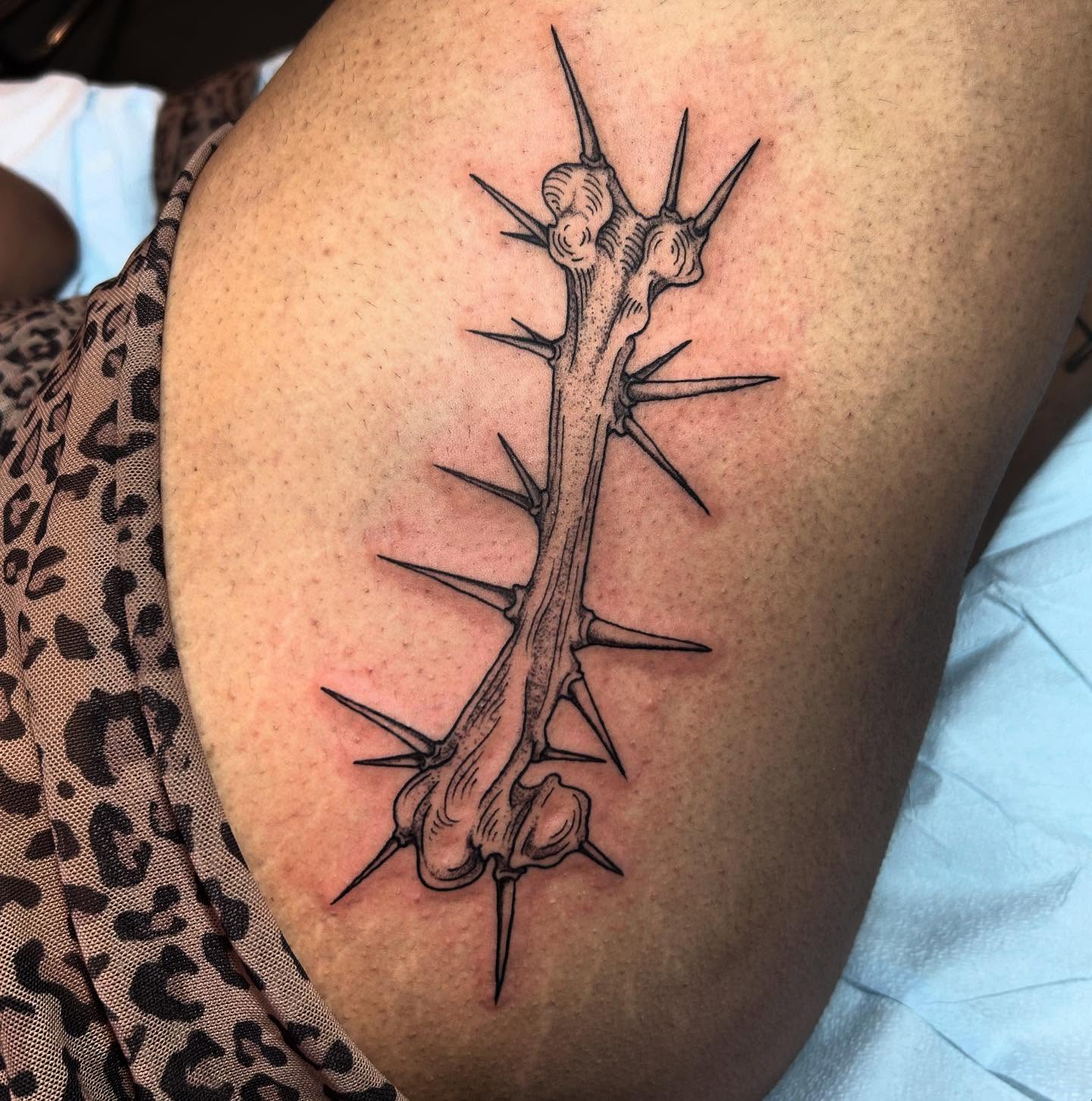 Thorn crown black and grey tattoo on the thigh by Nikki Power