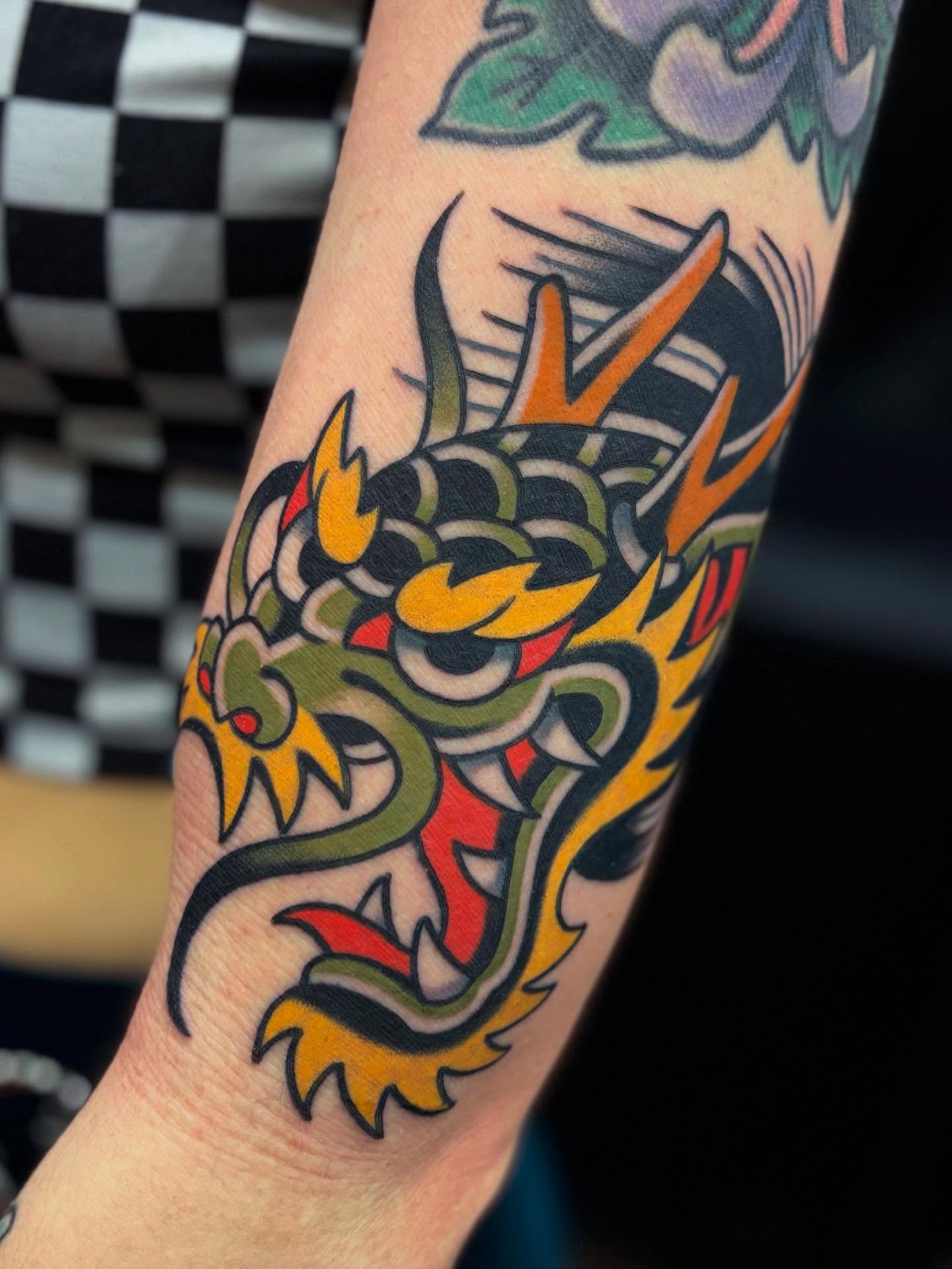 Dragon head American traditional tattoo on the forearm by Arturo Ledesma