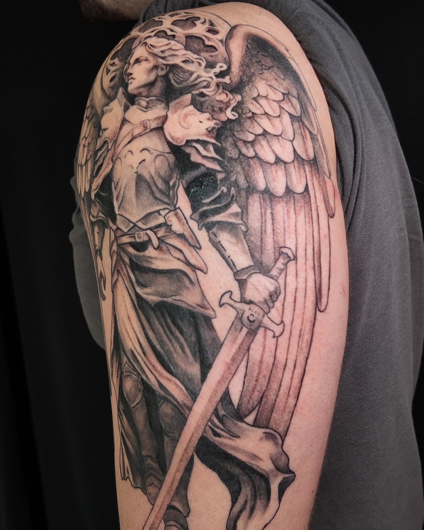 Angel with sword realism tattoo on the upper arm by Ben Cisek