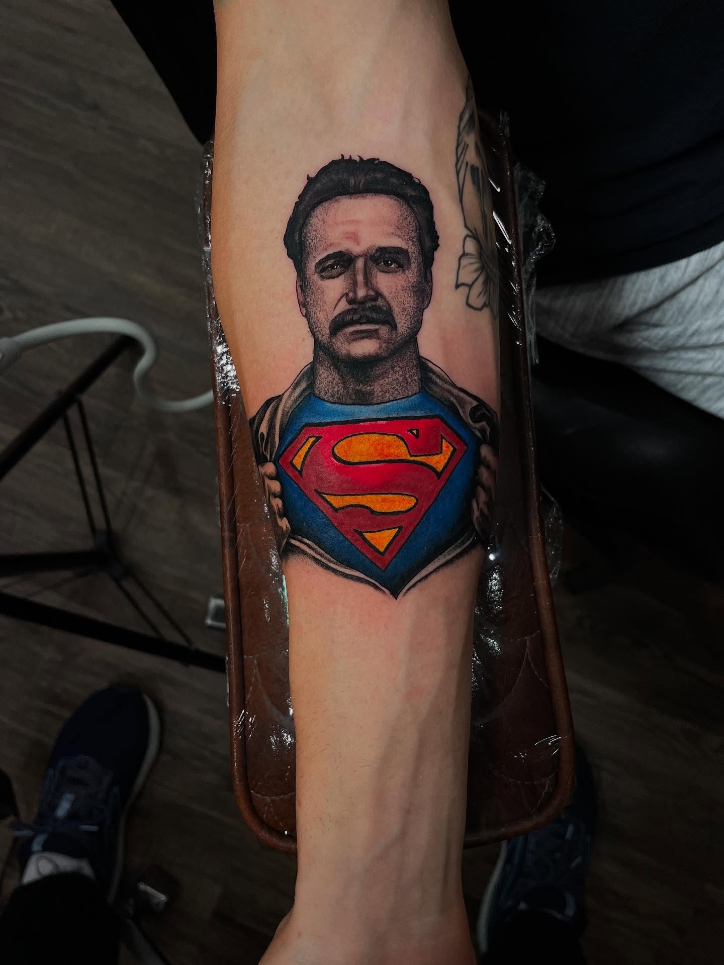 Superman realism tattoo on the forearm by Caleb Baker