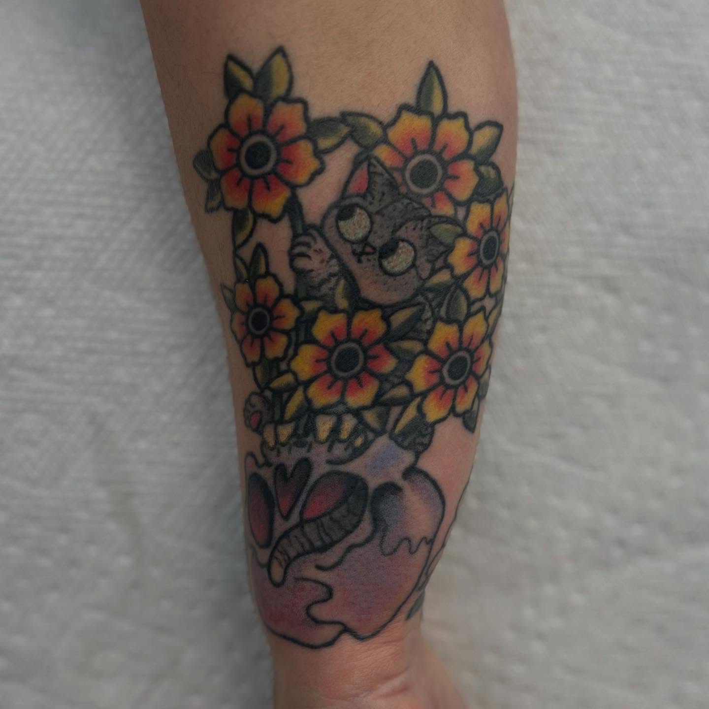 Cat among flowers American traditional tattoo on the forearm by Abby Watts, Columbus, Ohio
