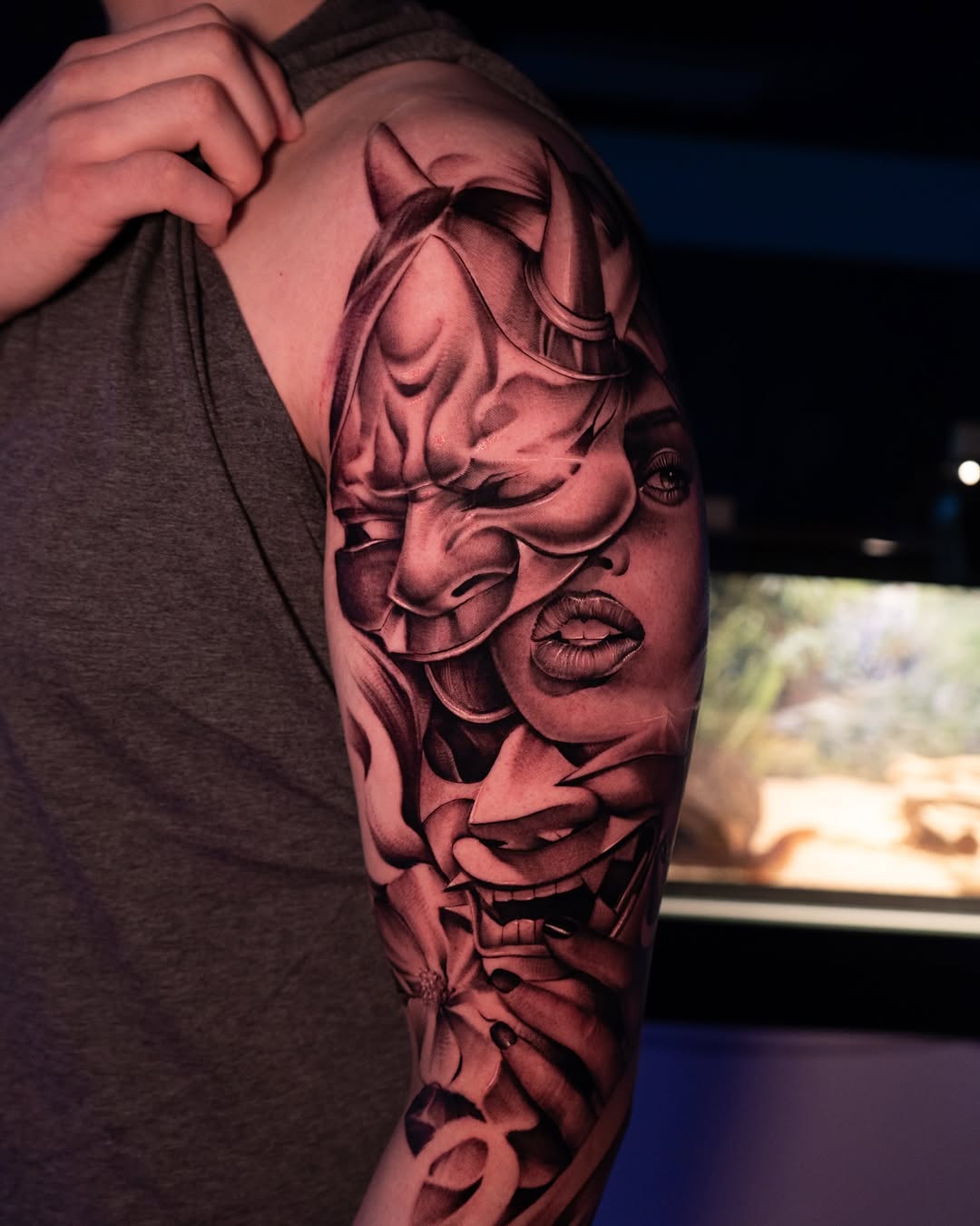 Hannya mask, female face, and flowers Japanese tattoo on the forearm by Apolo