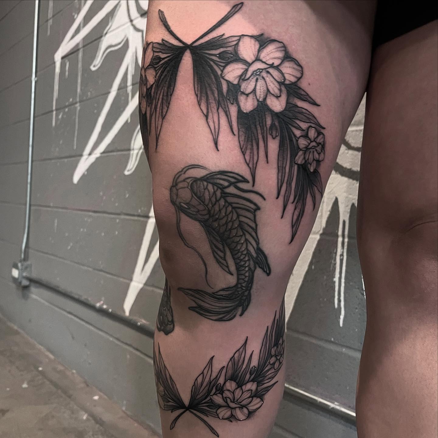 Koi fish and flowers black and grey tattoo on the thigh by Brandon Mola, Chicago, Illinois