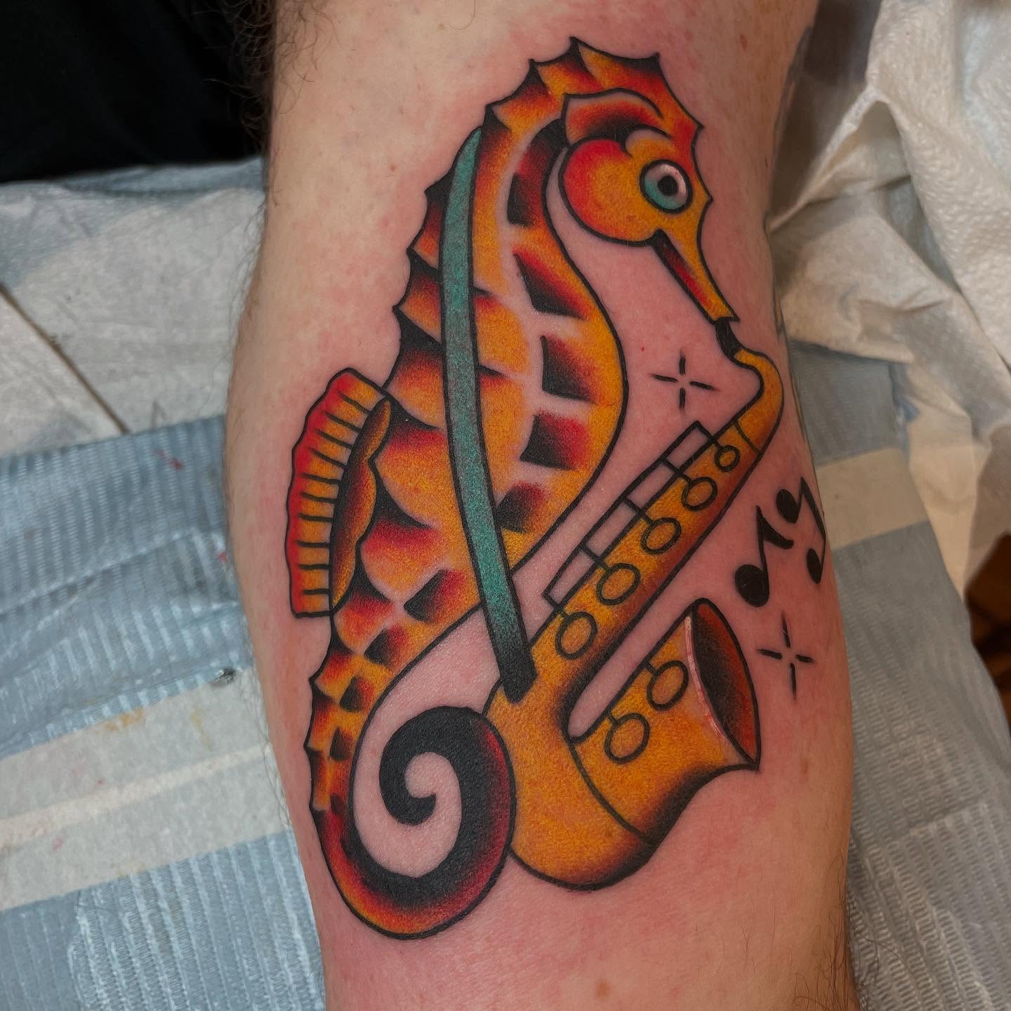 Seahorse and saxophone American traditional tattoo on the forearm by Grandma Approved, Chicago, Illinois