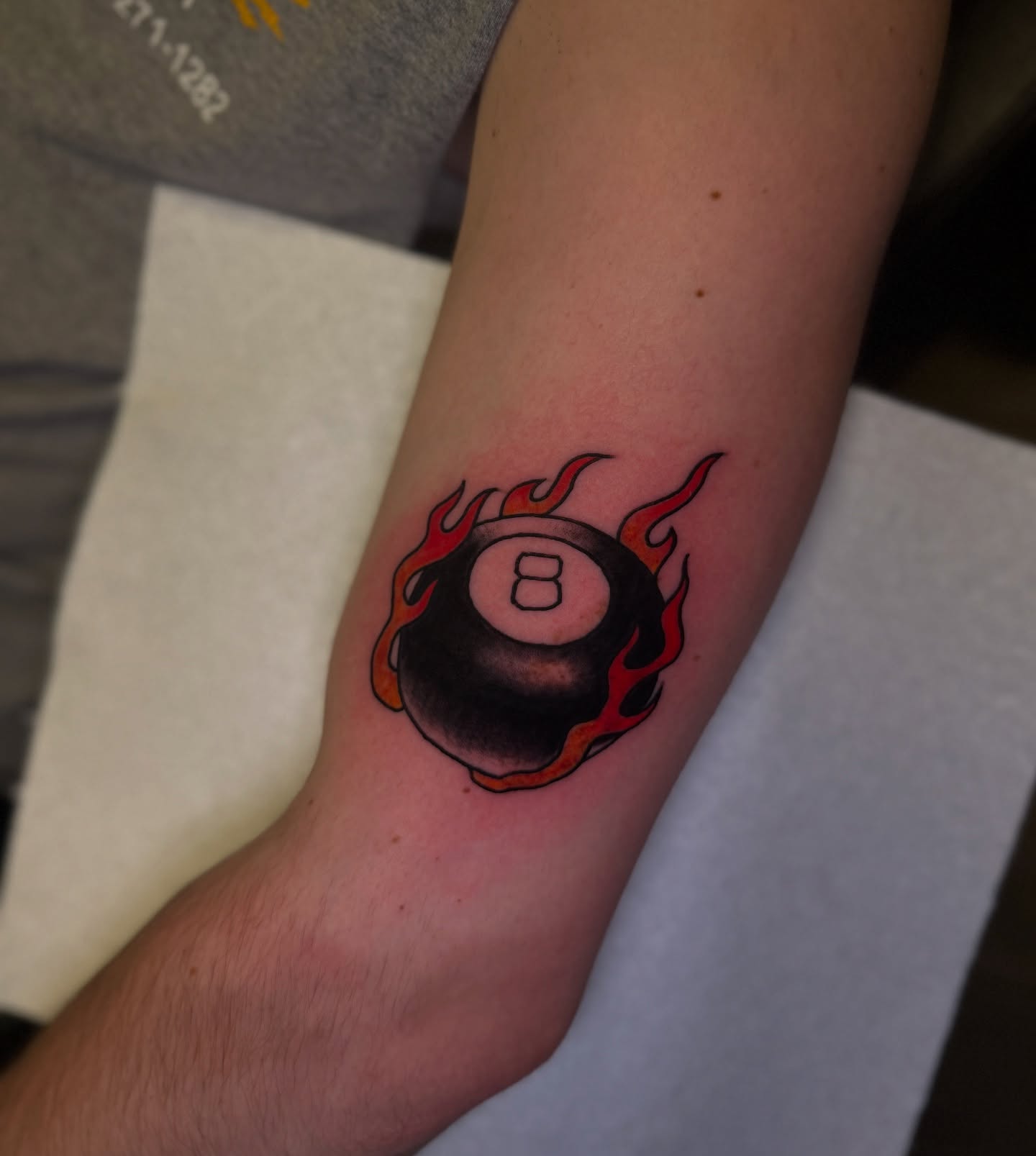 Flaming eight ball American traditional tattoo on the forearm by Preston-NJ Tattoo Artist