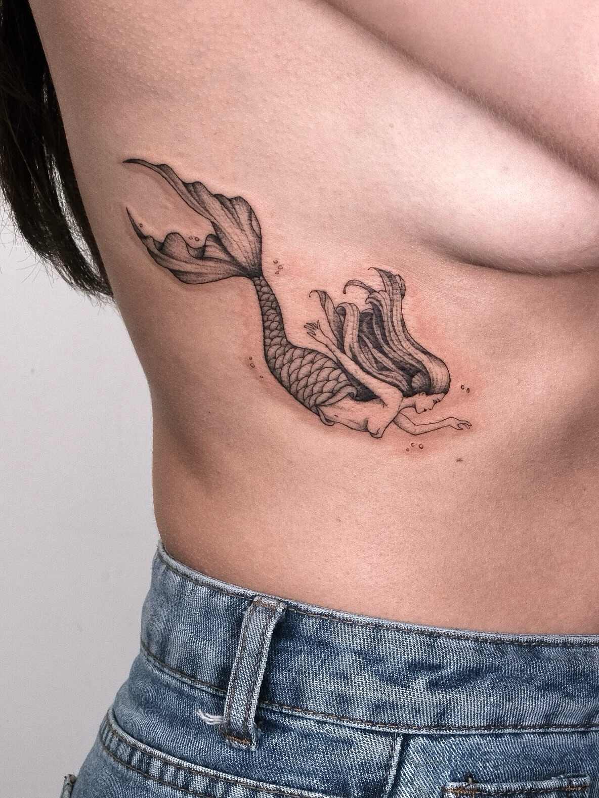 Mermaid black and grey tattoo on the ribs by Your tattoo Artist, New York, New York
