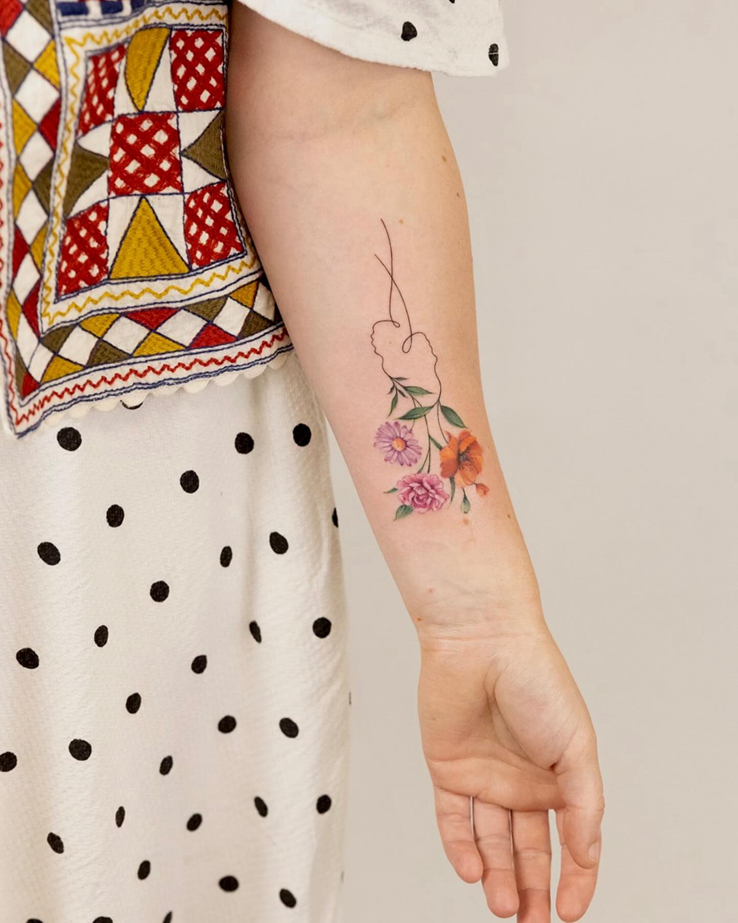 Floral bouquet watercolor tattoo on the forearm by Thin line and color TATTOO.
