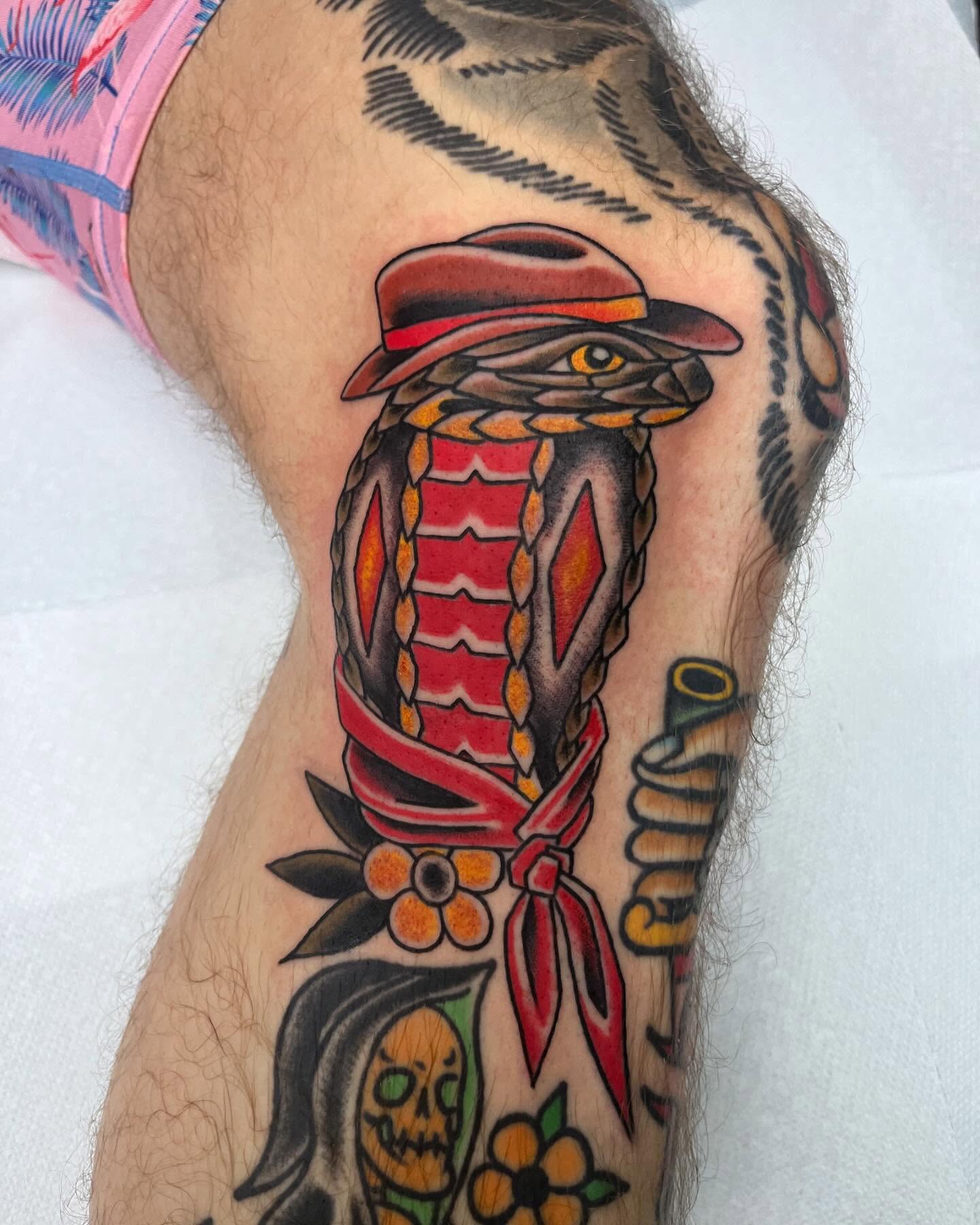 Snake with bandana American traditional tattoo on the forearm by Brian Mcfadden