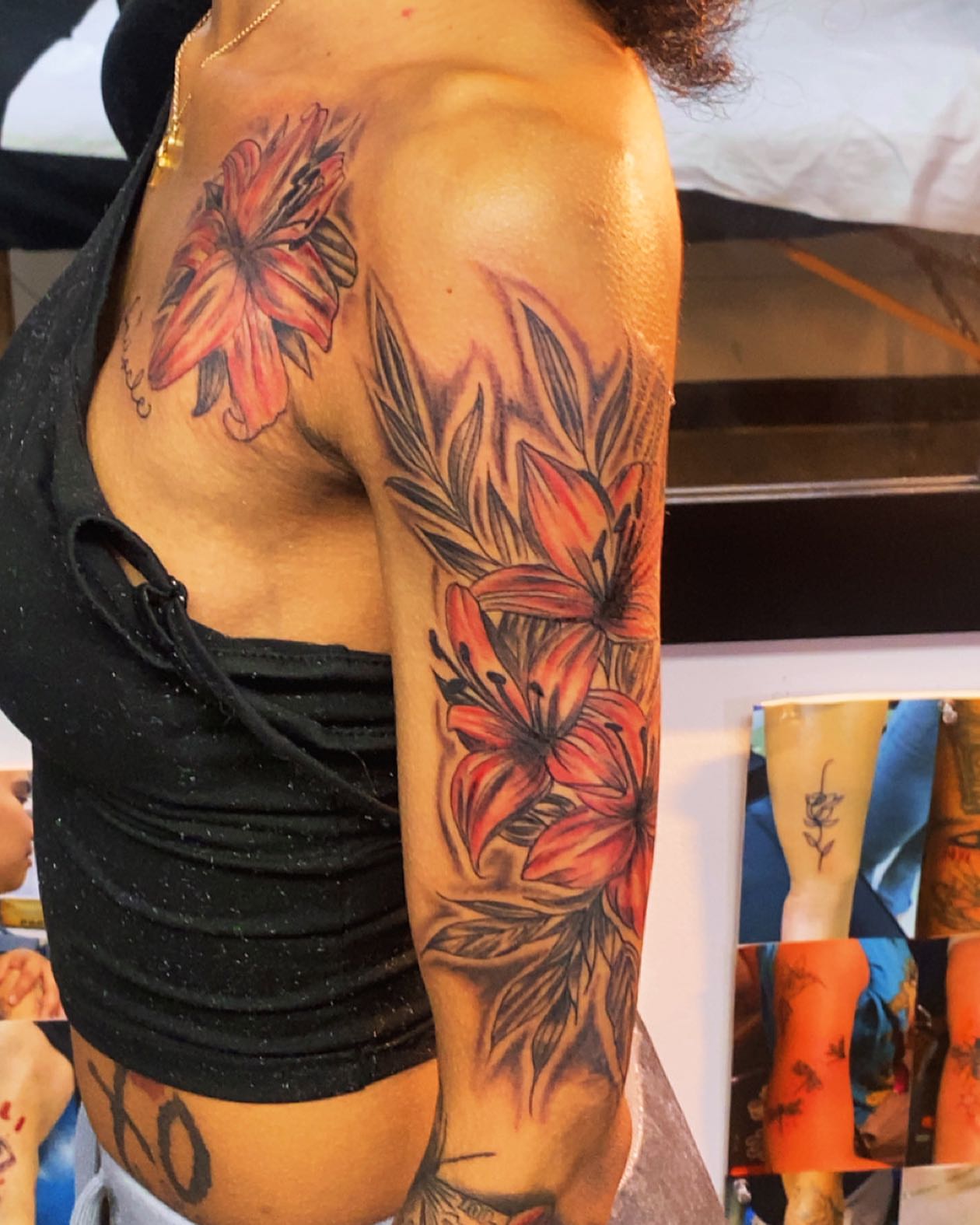 Lilies realism tattoo on the upper arm by Tattsruru