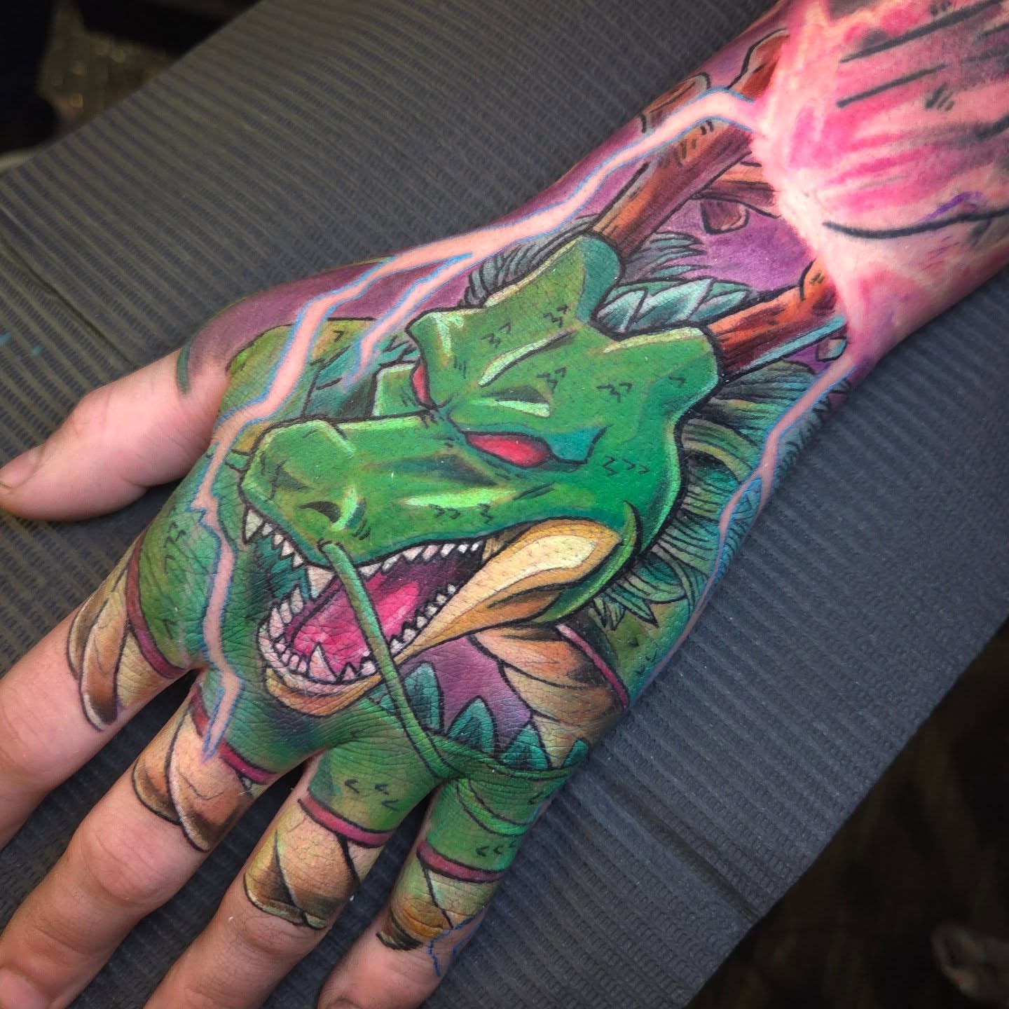 Dragon American traditional tattoo on the hand by Nic Mann