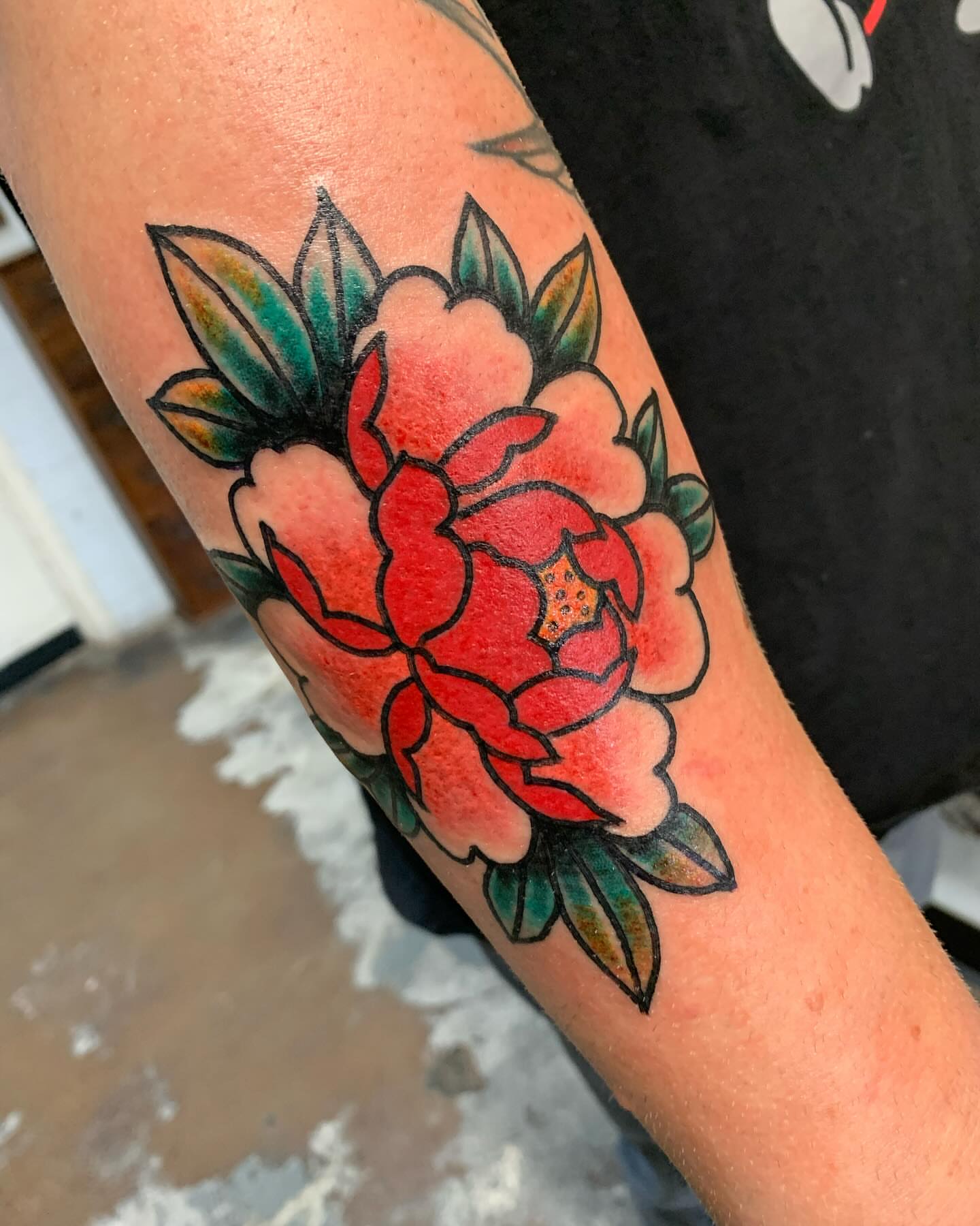 Peony American traditional tattoo on the forearm by Chrissie