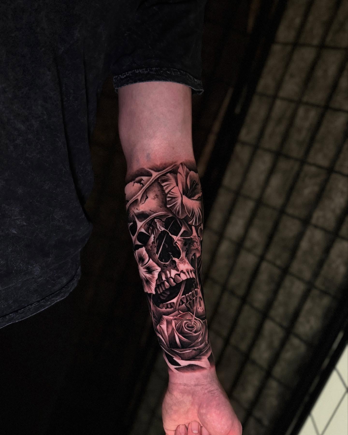 Skull and rose realism tattoo on the forearm by Miles Johnson