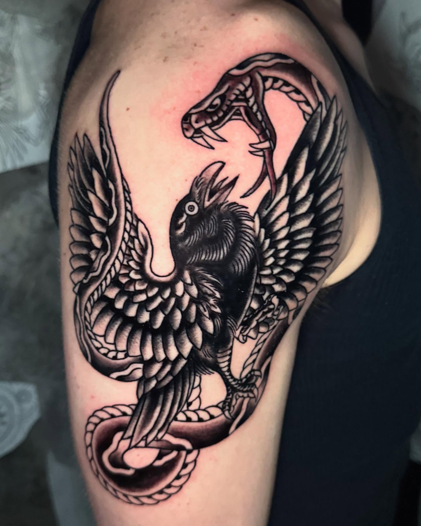 Raven and snake black and grey tattoo on the shoulder by Seth Walker