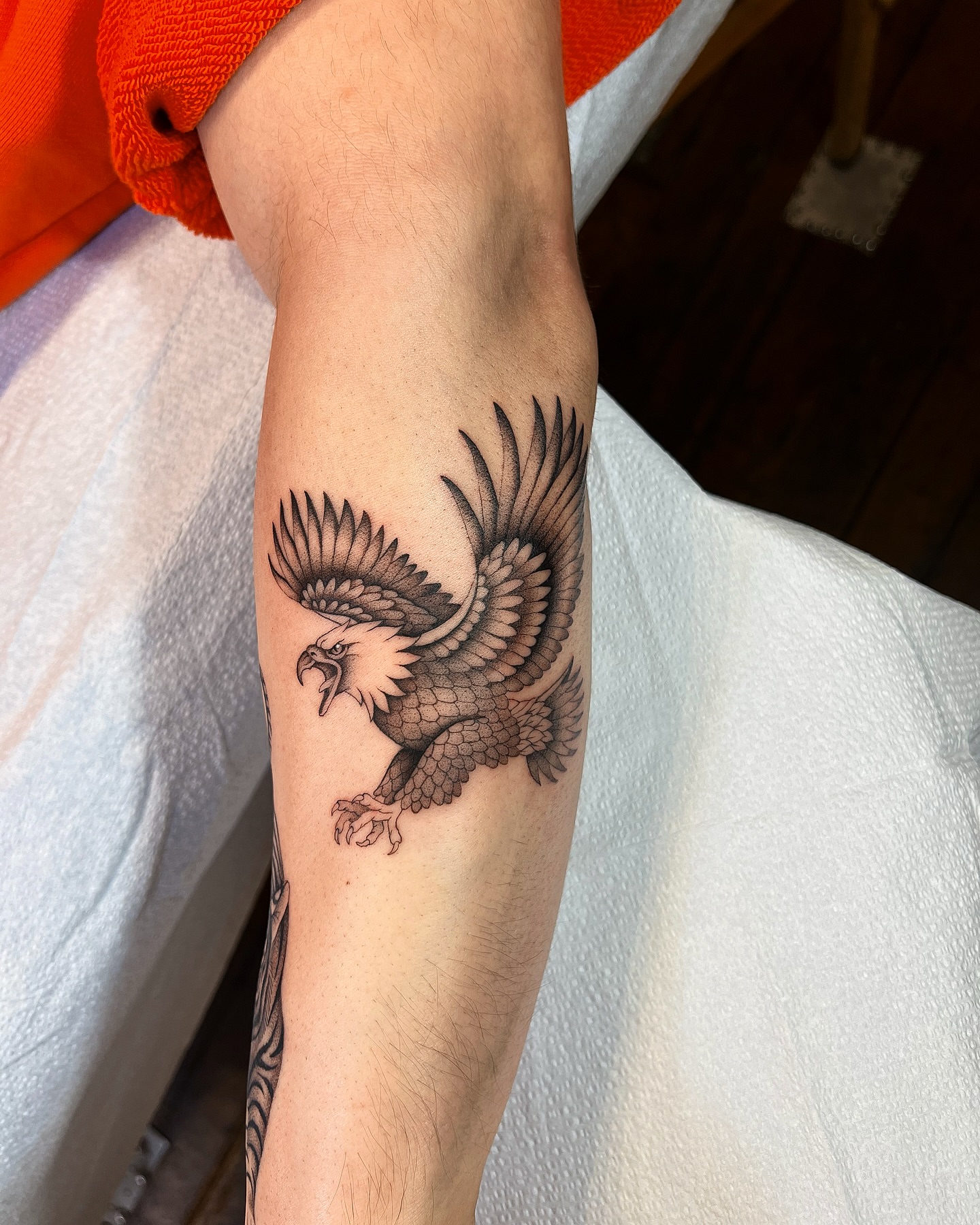 Eagle black and grey tattoo on the forearm by Mickey