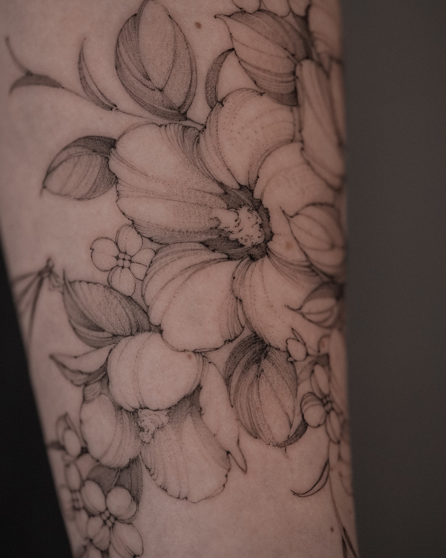 Floral bouquet black and grey tattoo on the forearm by Mary Shekh