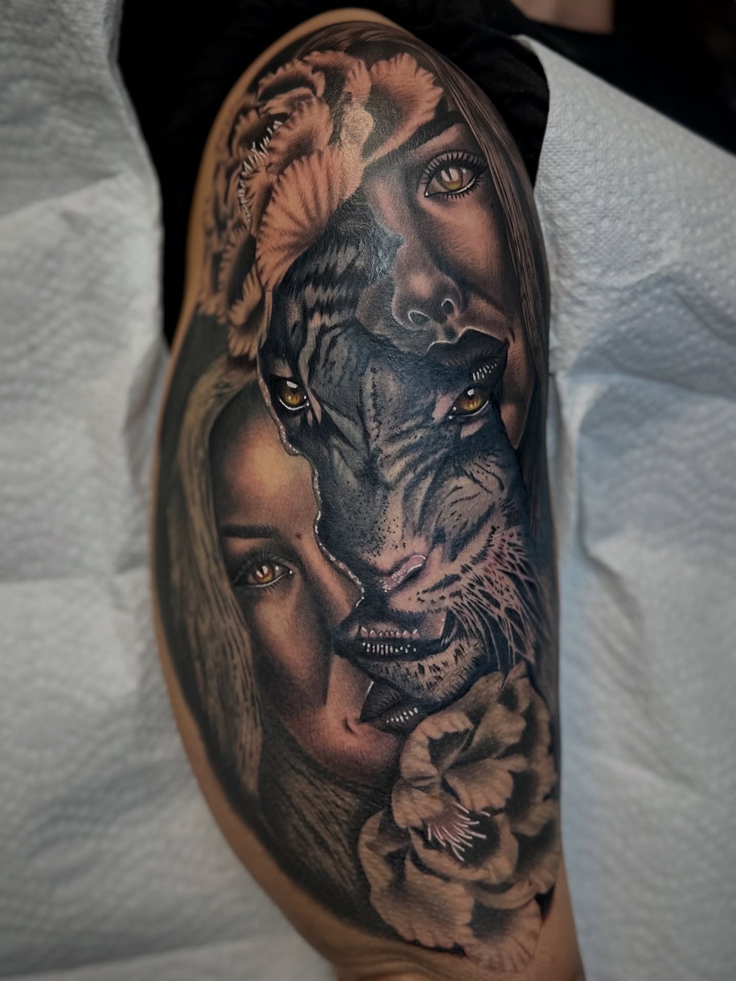 Woman and tiger realism tattoo on the forearm by Savannah Compton