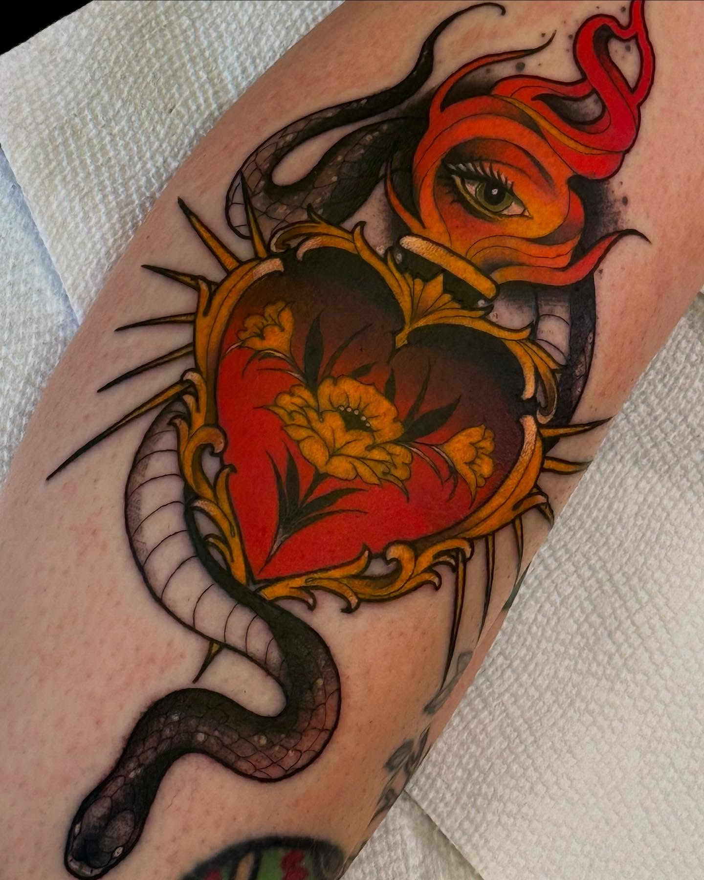 Heart with snake American traditional tattoo on the forearm by Espinal