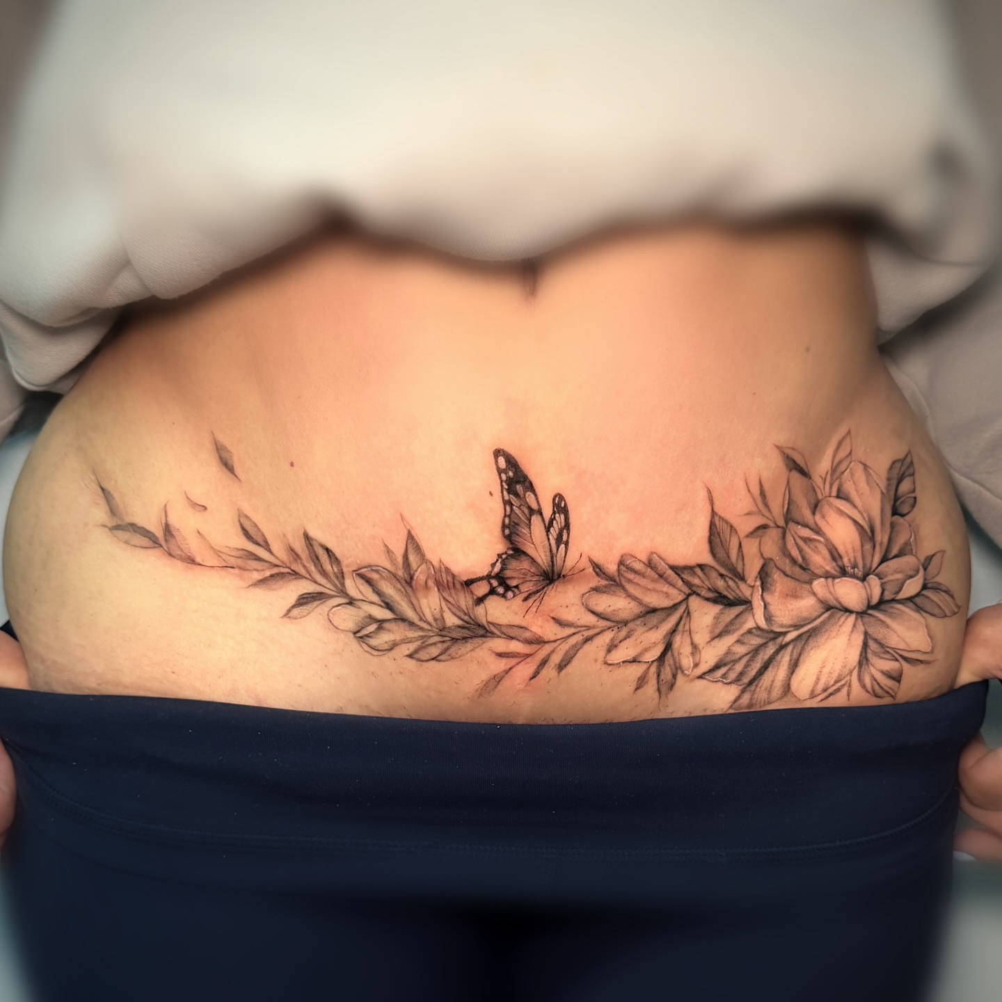 Butterfly and flowers realism tattoo on the torso by Nyc Tattoo Manhattan