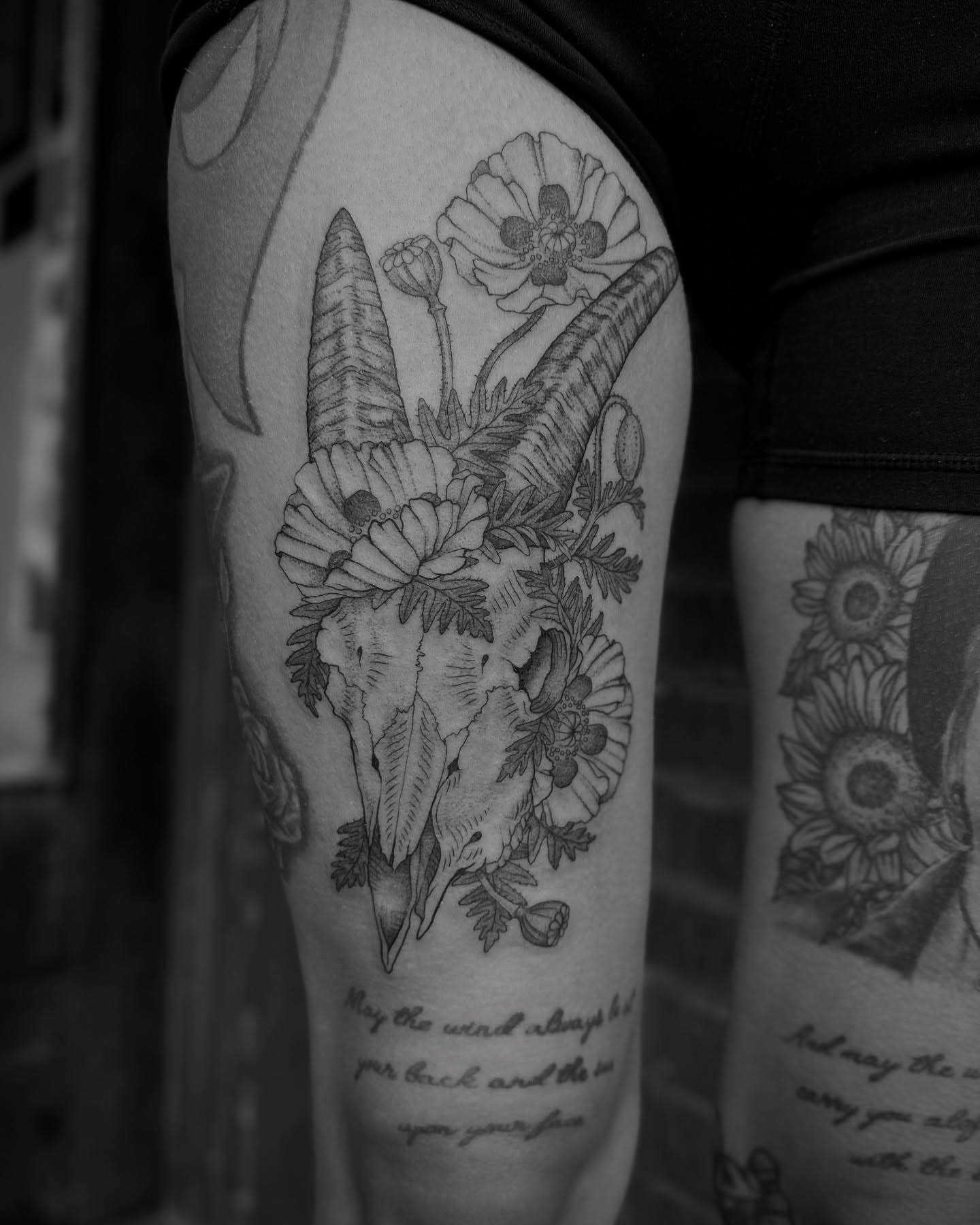 Goat skull with flowers realism tattoo on the forearm by Alex Brooke