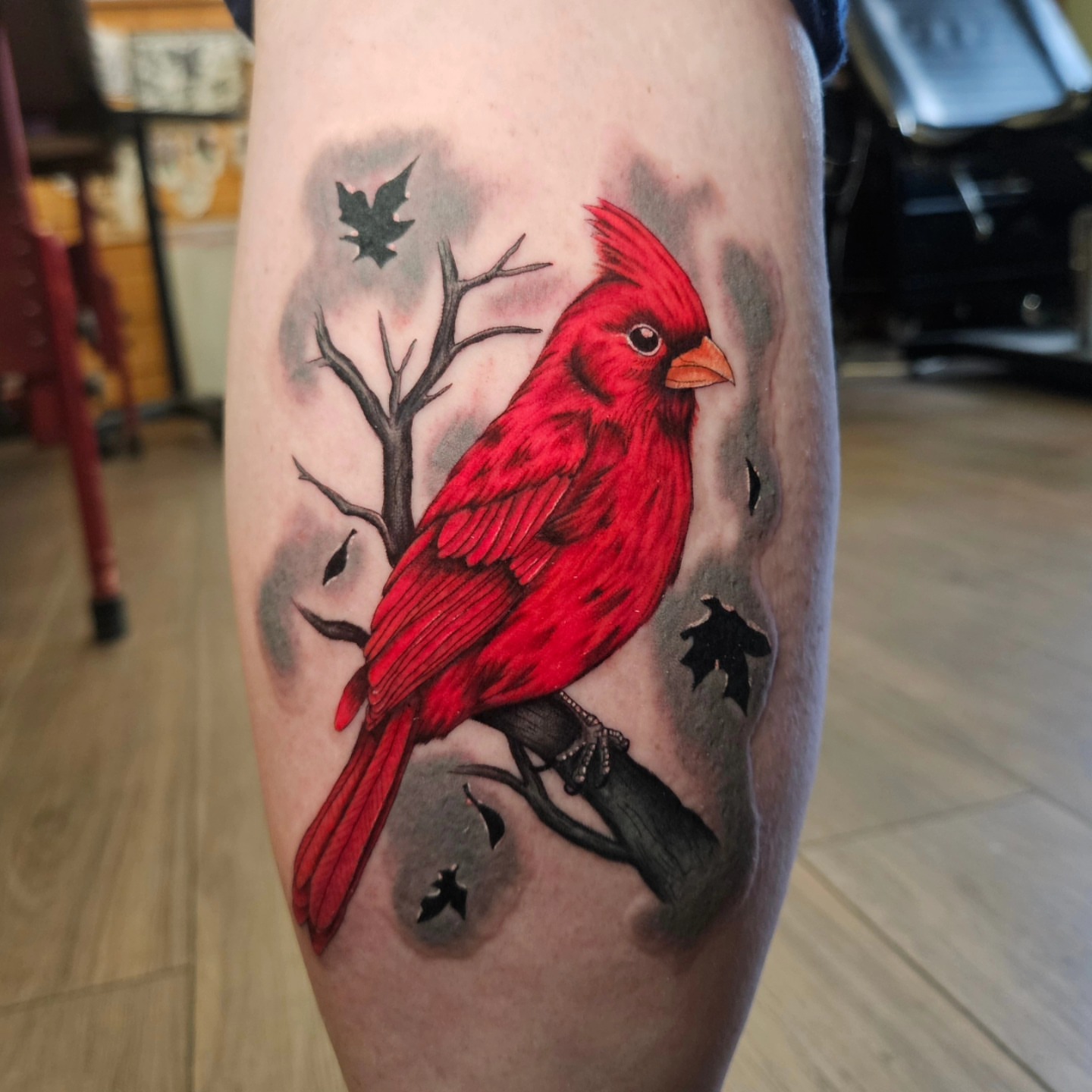 Red cardinal realism tattoo on the forearm by Nicole Bett