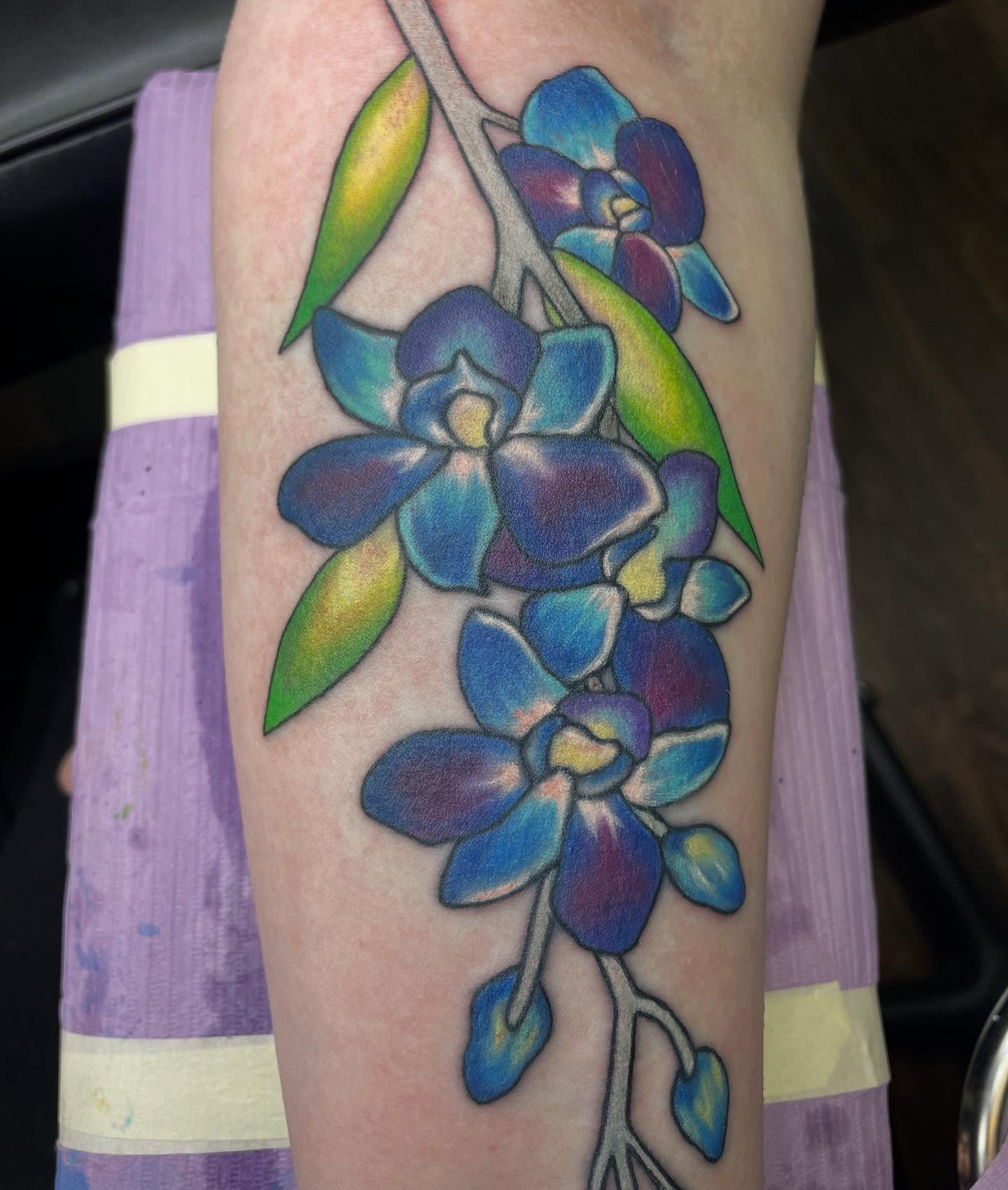 Orchid realism tattoo on the forearm by Alexis Monkiewicz
