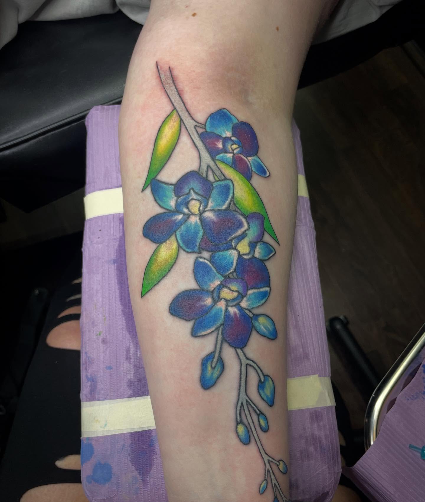 Blue orchid new school tattoo on the forearm by Alexis Monkiewicz