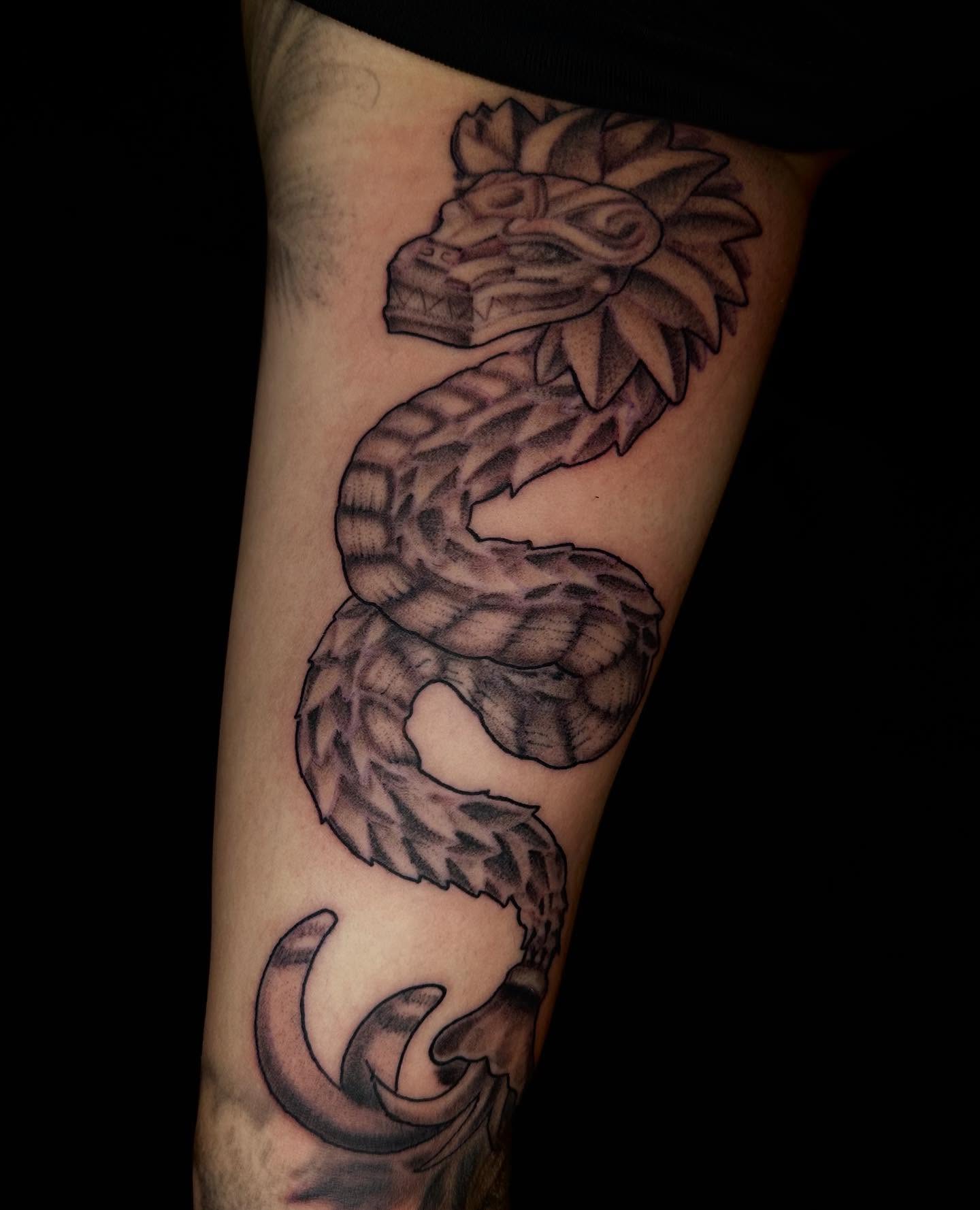 Serpent black and grey tattoo on the forearm by Jay Morales