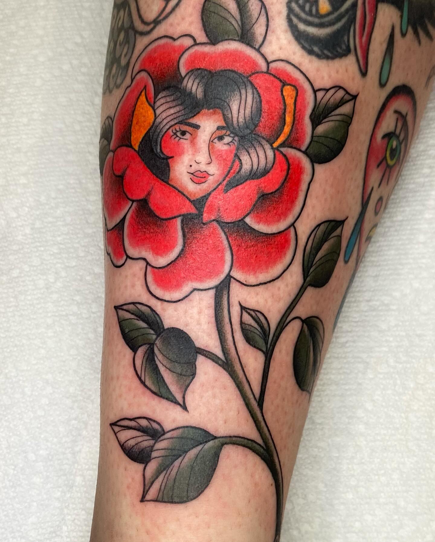 Flower with woman's face American traditional tattoo on the forearm by Kiera ❤️‍🔥
