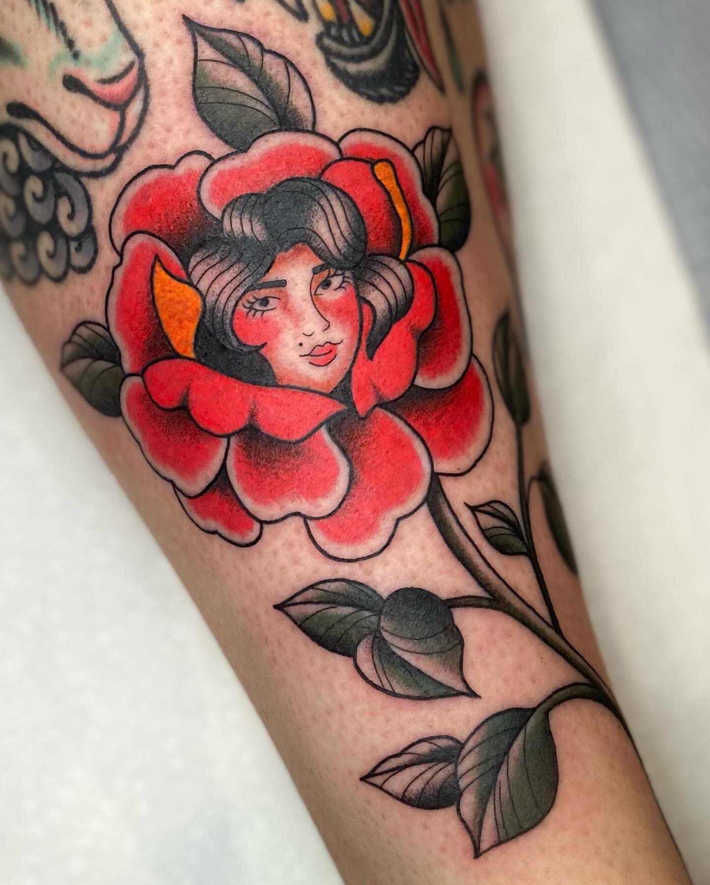 Flower with woman's face American traditional tattoo on the forearm by Kiera ❤️‍🔥