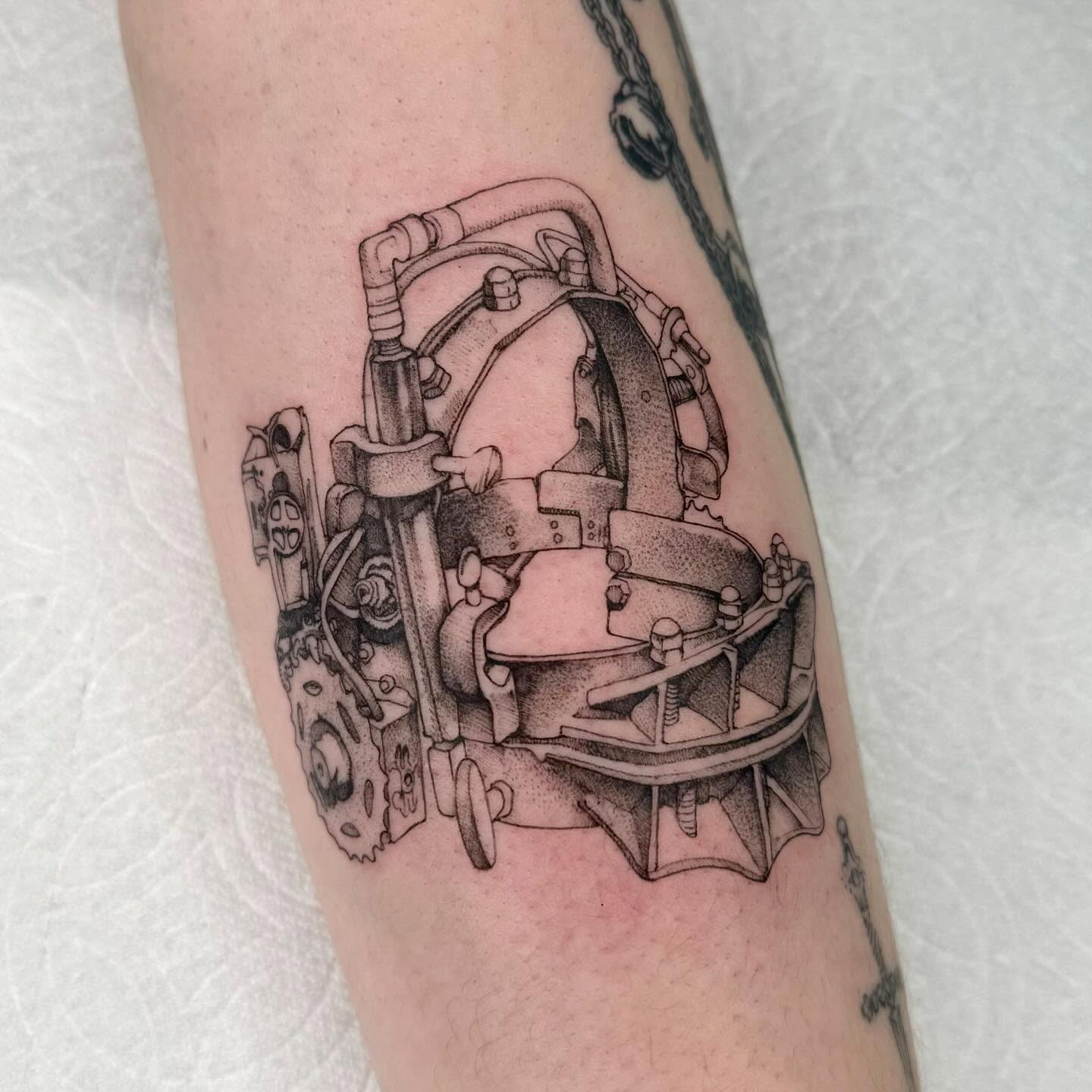 Mechanical device dotwork tattoo on the forearm by taline