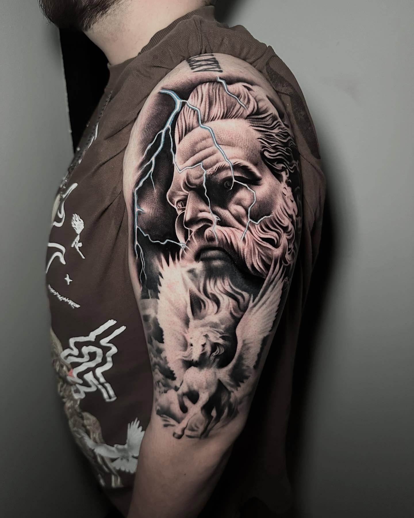 God with lightning realism tattoo on the shoulder by Miguel Saucedo