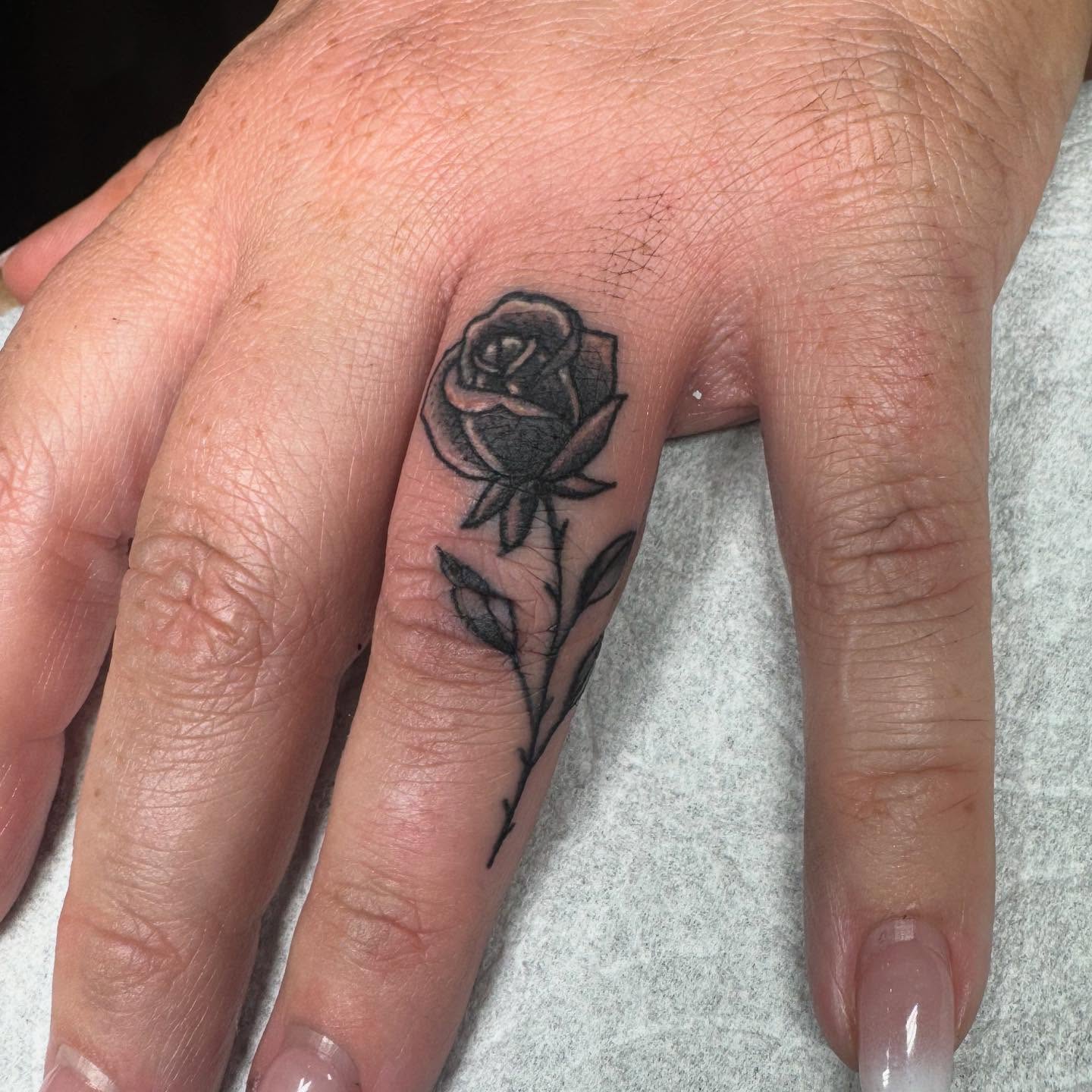 Rose black and grey tattoo on the hand by Justina🪐