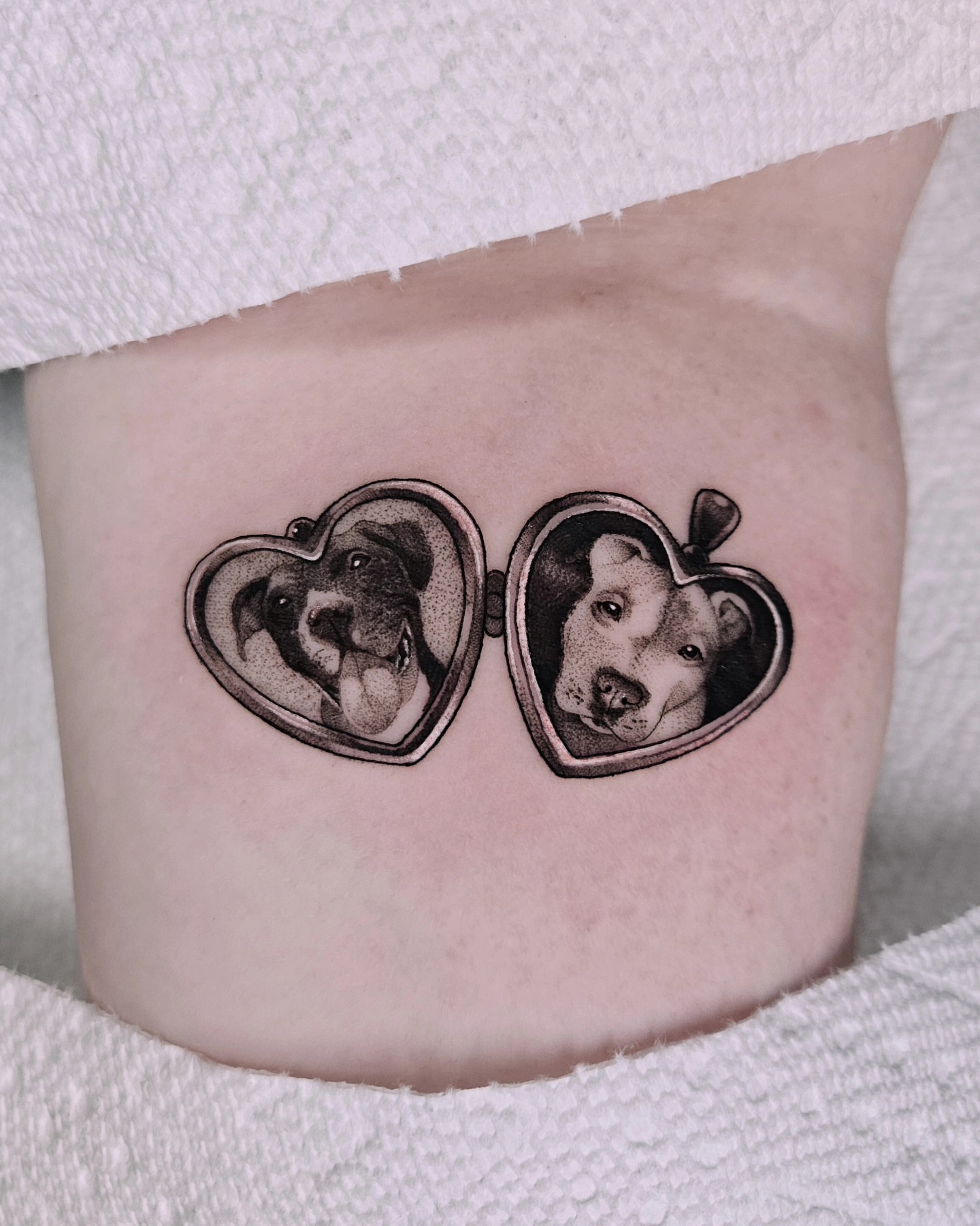 Heart-shaped locket with dog dotwork tattoo on the thigh by Sabrina Wagner