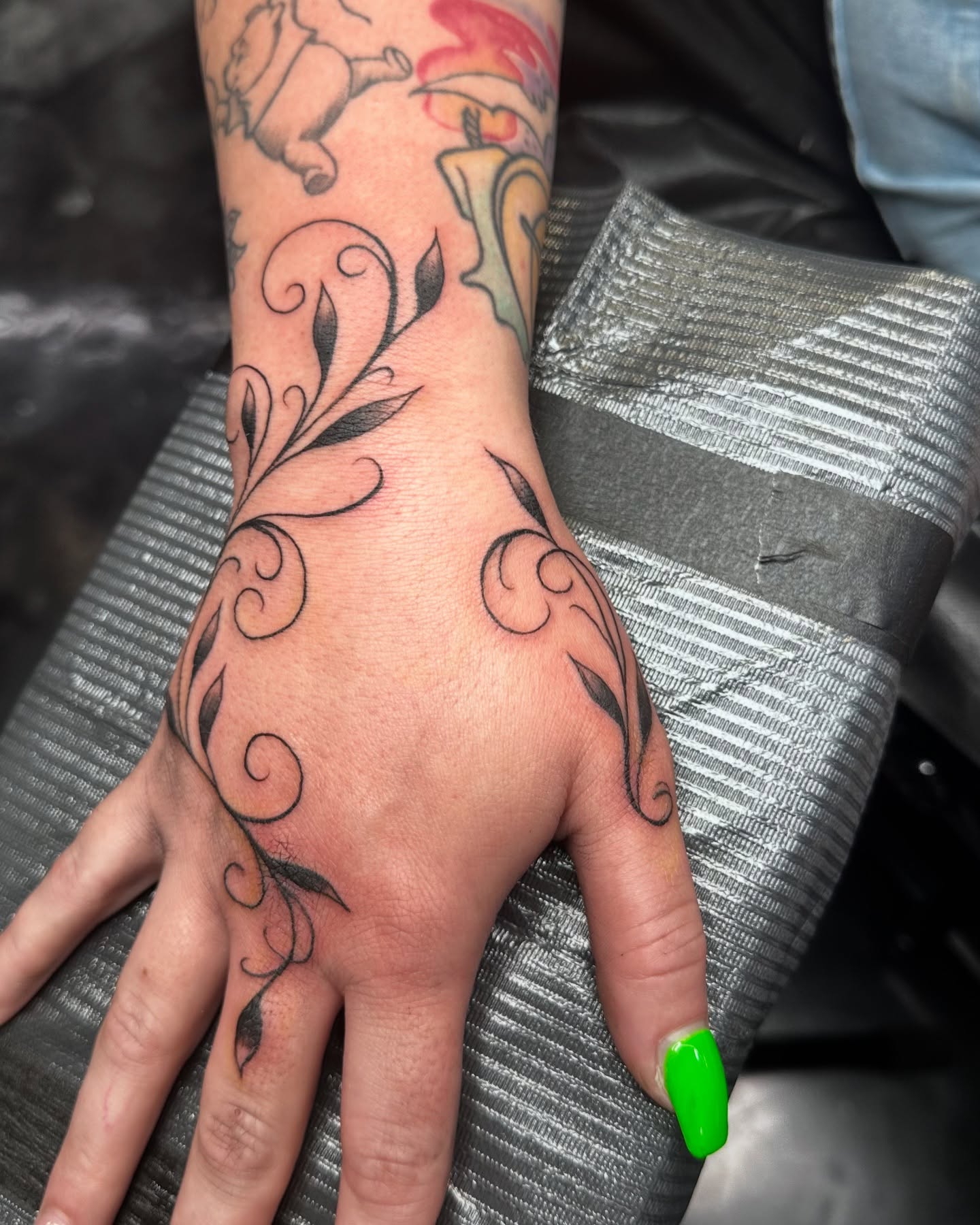 Scrollwork fine line tattoo on the hand by Greg Romero (el chamo), Millcreek, Utah