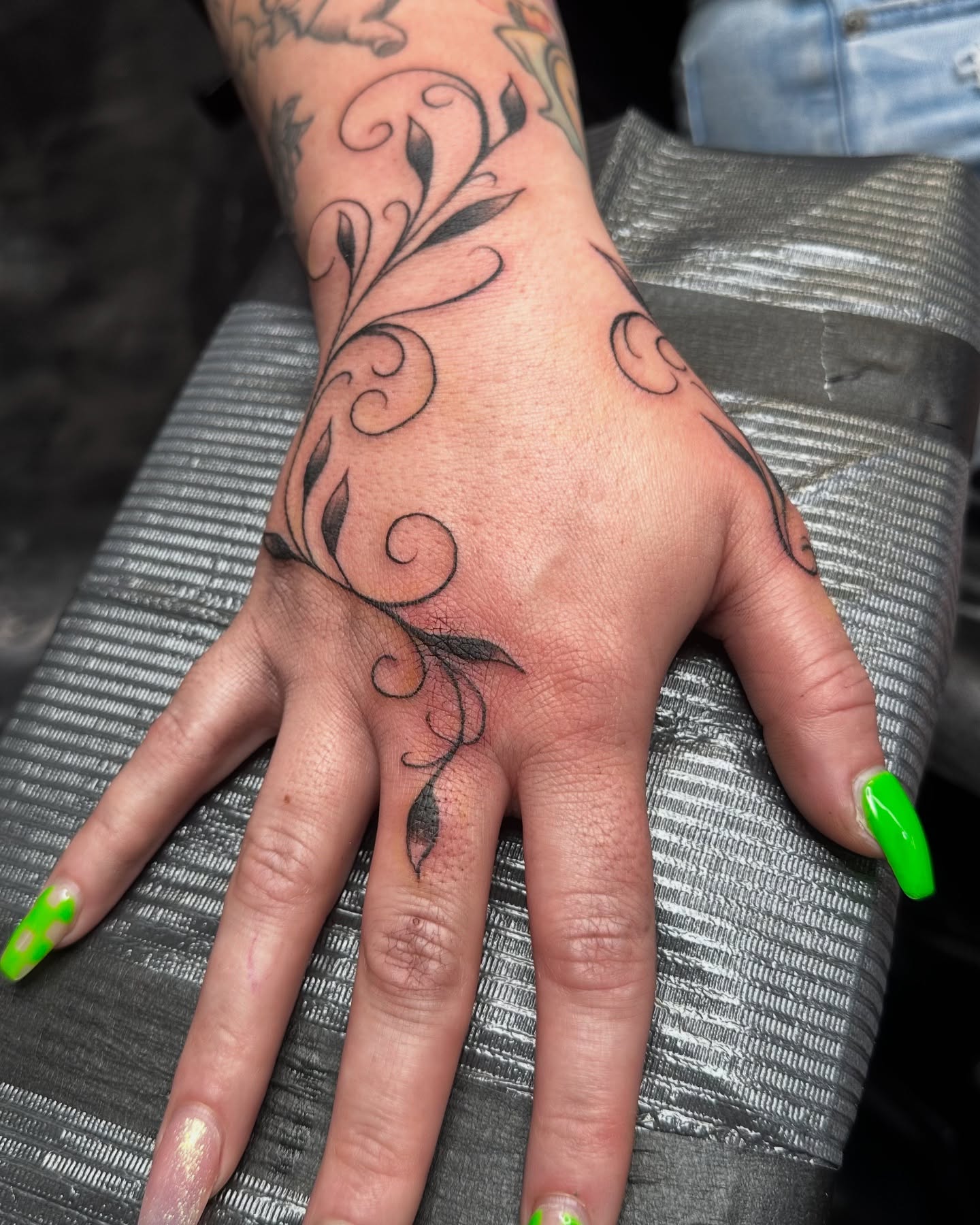 Floral vine black and grey tattoo on the hand by Greg Romero (el chamo), Millcreek, Utah