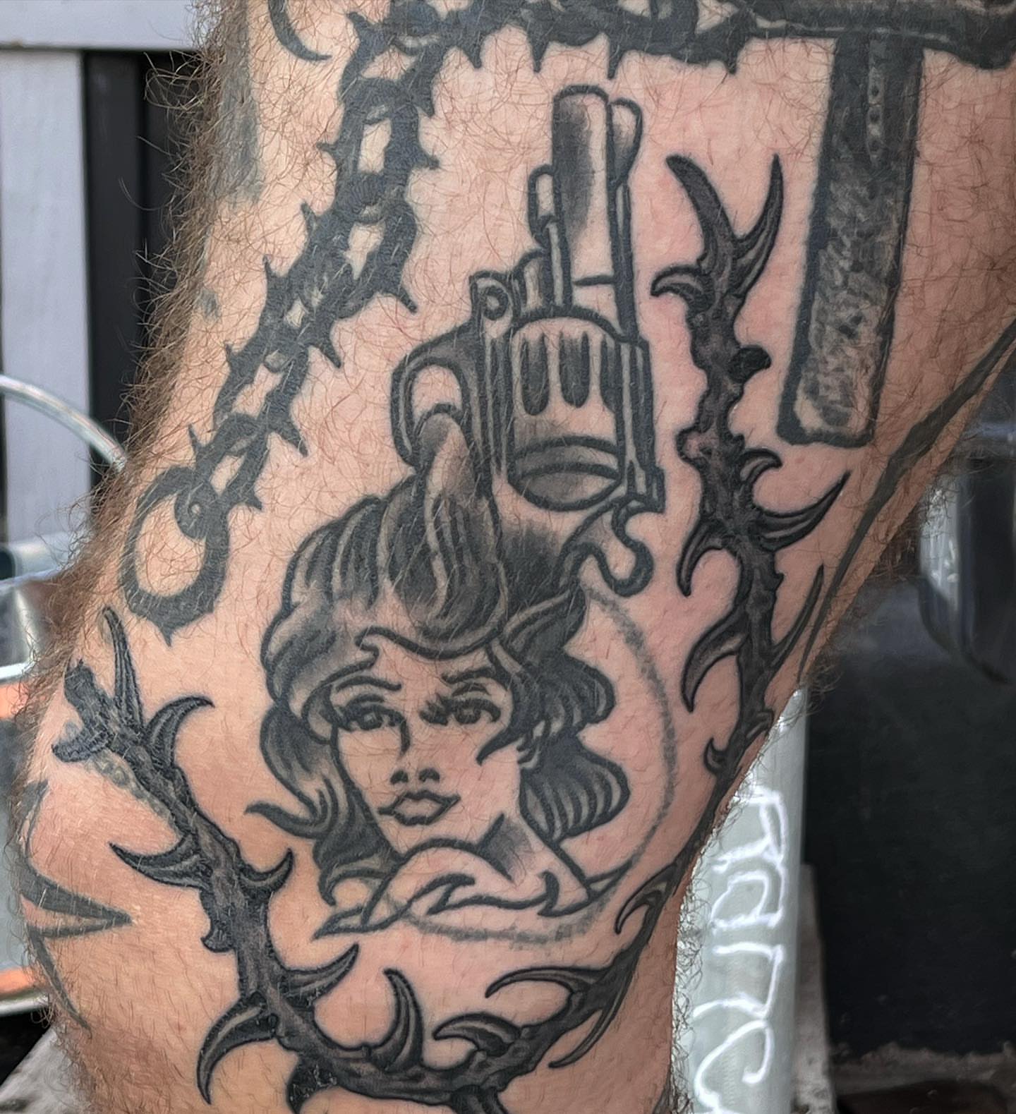 Woman with gun American traditional tattoo on the forearm by TYP 419, Toledo, Ohio