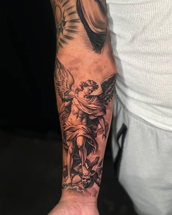 Angel with demon realism tattoo on the forearm by Carlos Lujan