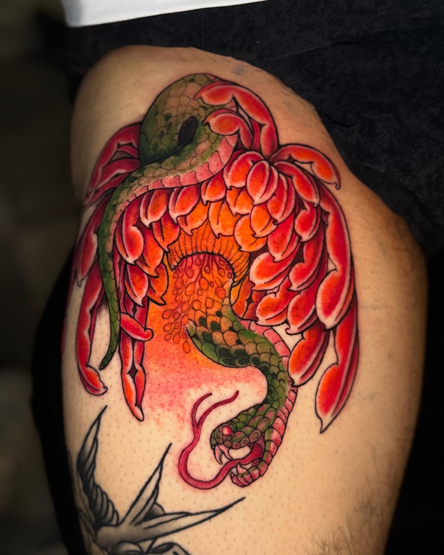Snake and peony American traditional tattoo on the thigh by Brandon Seven