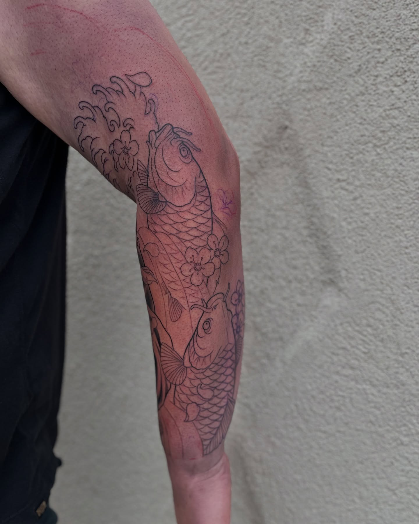 Koi fish and cherry blossoms black and grey tattoo on the forearm by Angelique Sanders, Tellico Plains, Tennessee