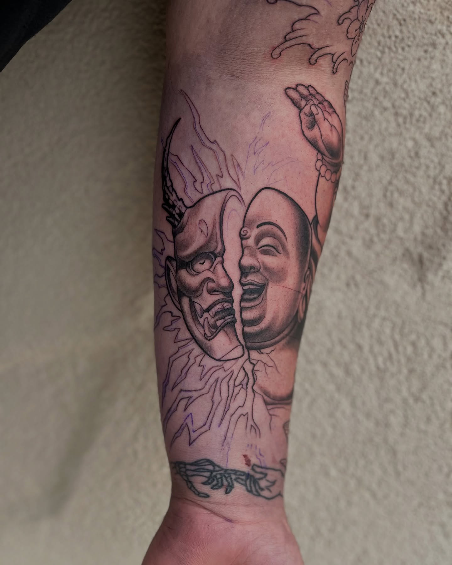 Demon and baby black and grey tattoo on the forearm by Angelique Sanders, Tellico Plains, Tennessee