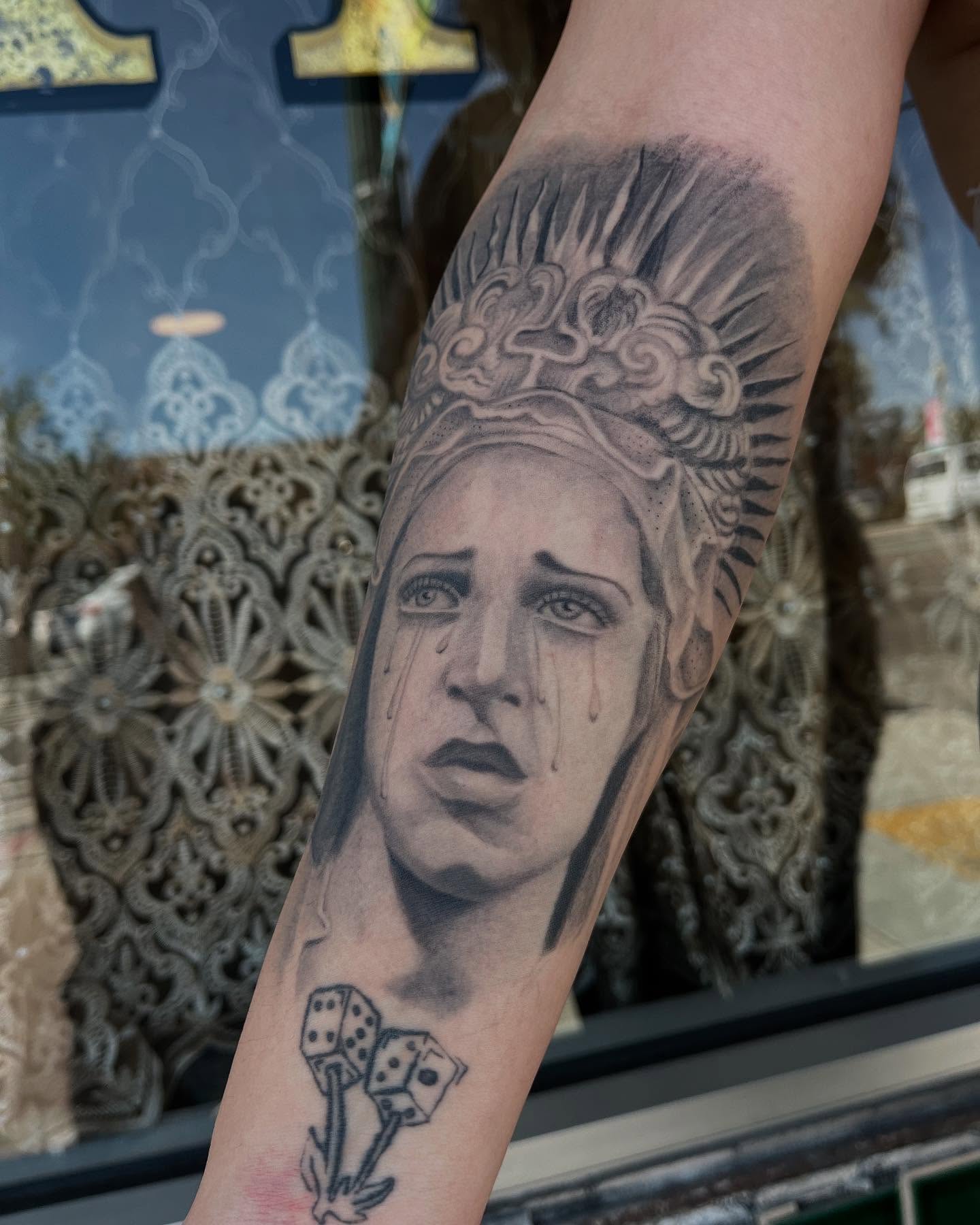Woman crying realism tattoo on the forearm by San Diego tattoo artist
