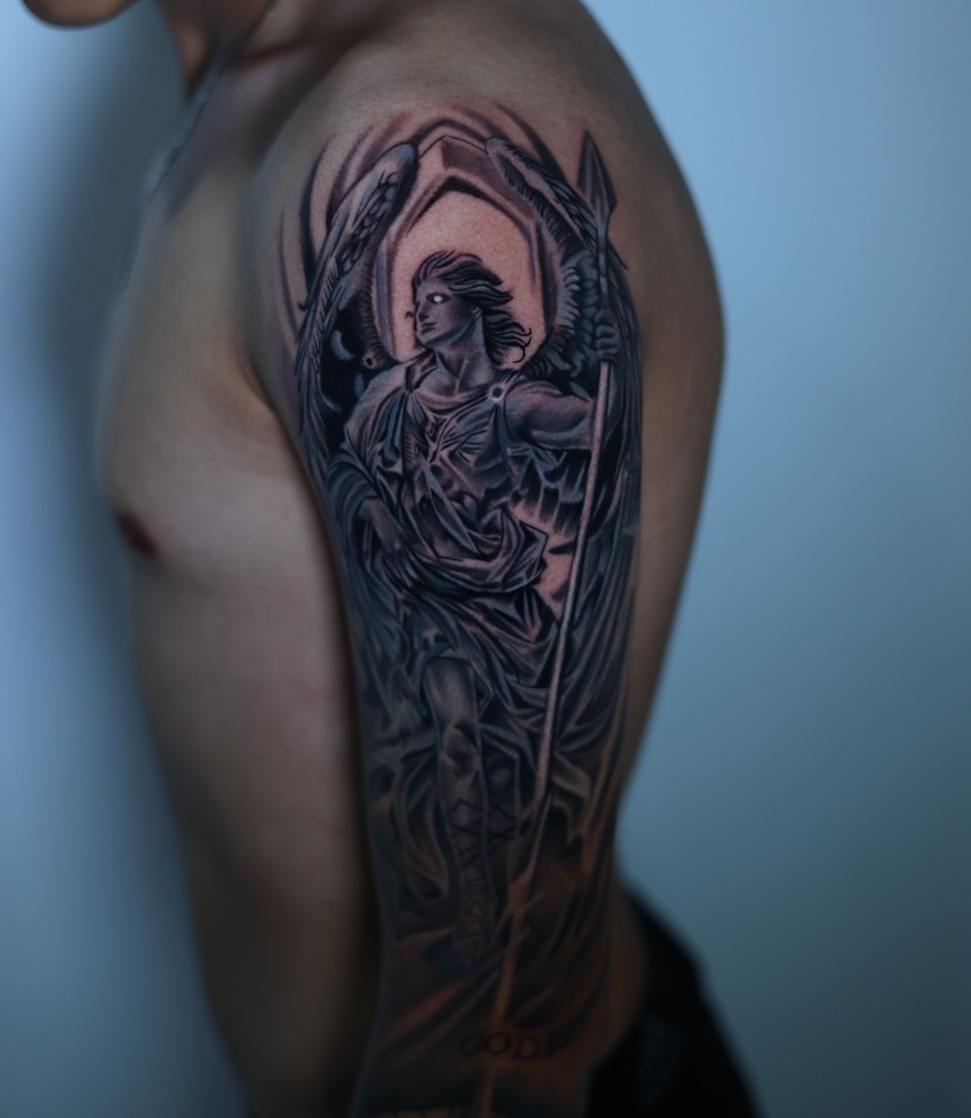 Angel with sword realism tattoo on the upper arm by Tiago Ink