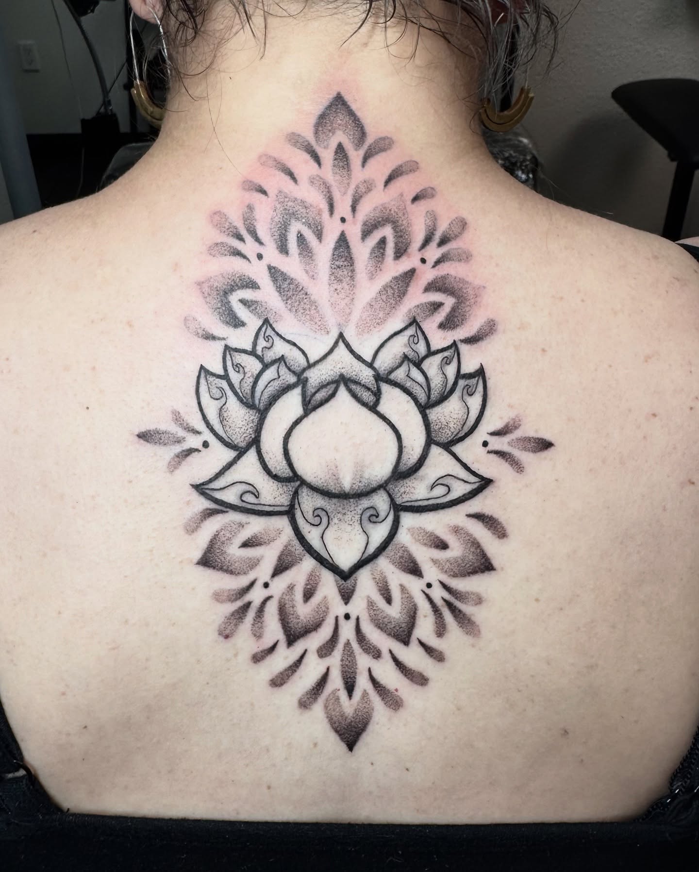 Lotus flower dotwork tattoo on the back by Jess