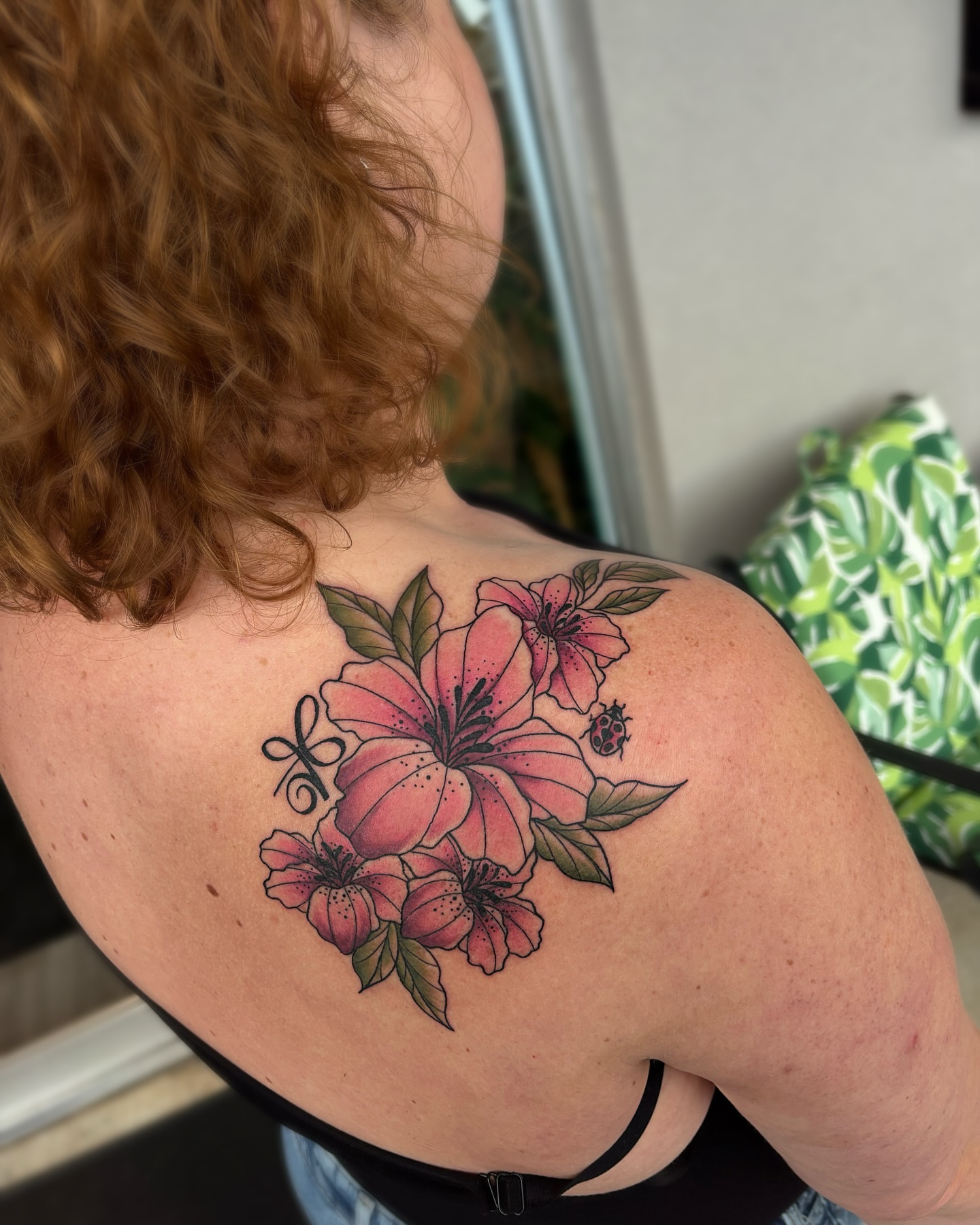 Lilies realism tattoo on the shoulder by Bunny Noel