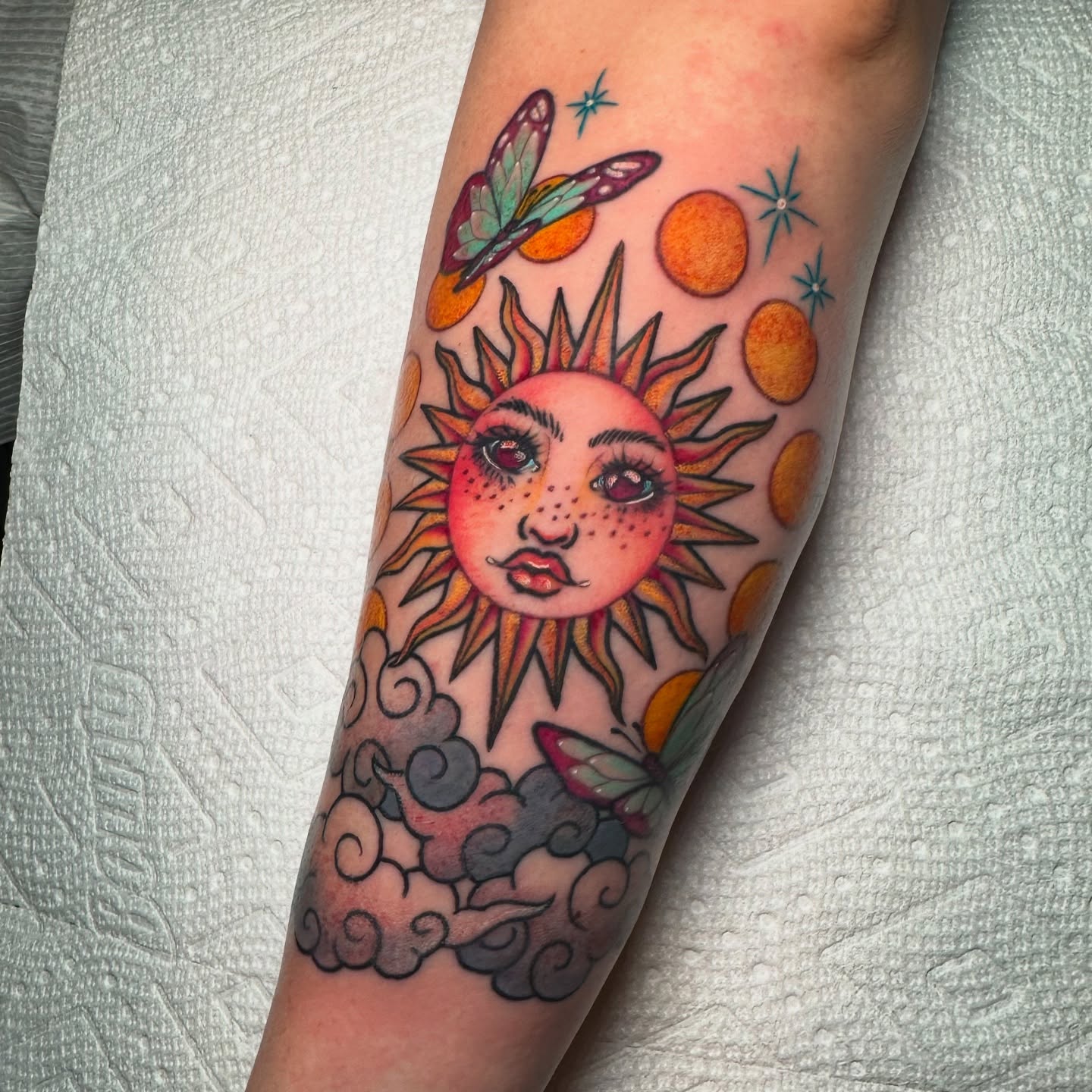 Sun new school tattoo on the forearm by Tayler Pearson, Fort Collins, Colorado