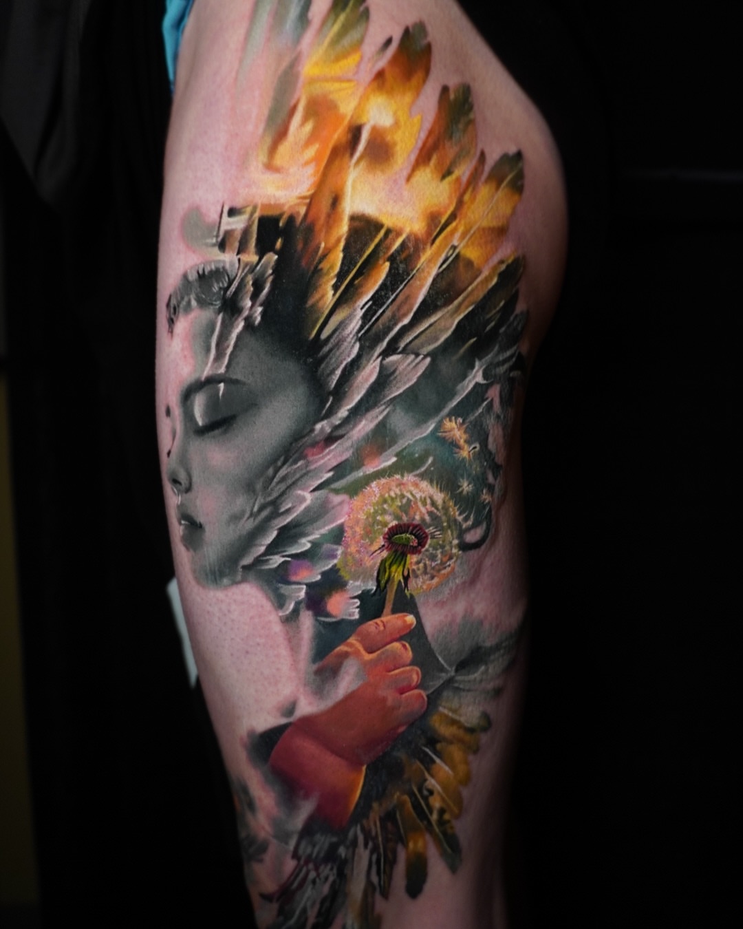 Woman with dandelion surrealism tattoo on the upper arm by Justin Shelpman