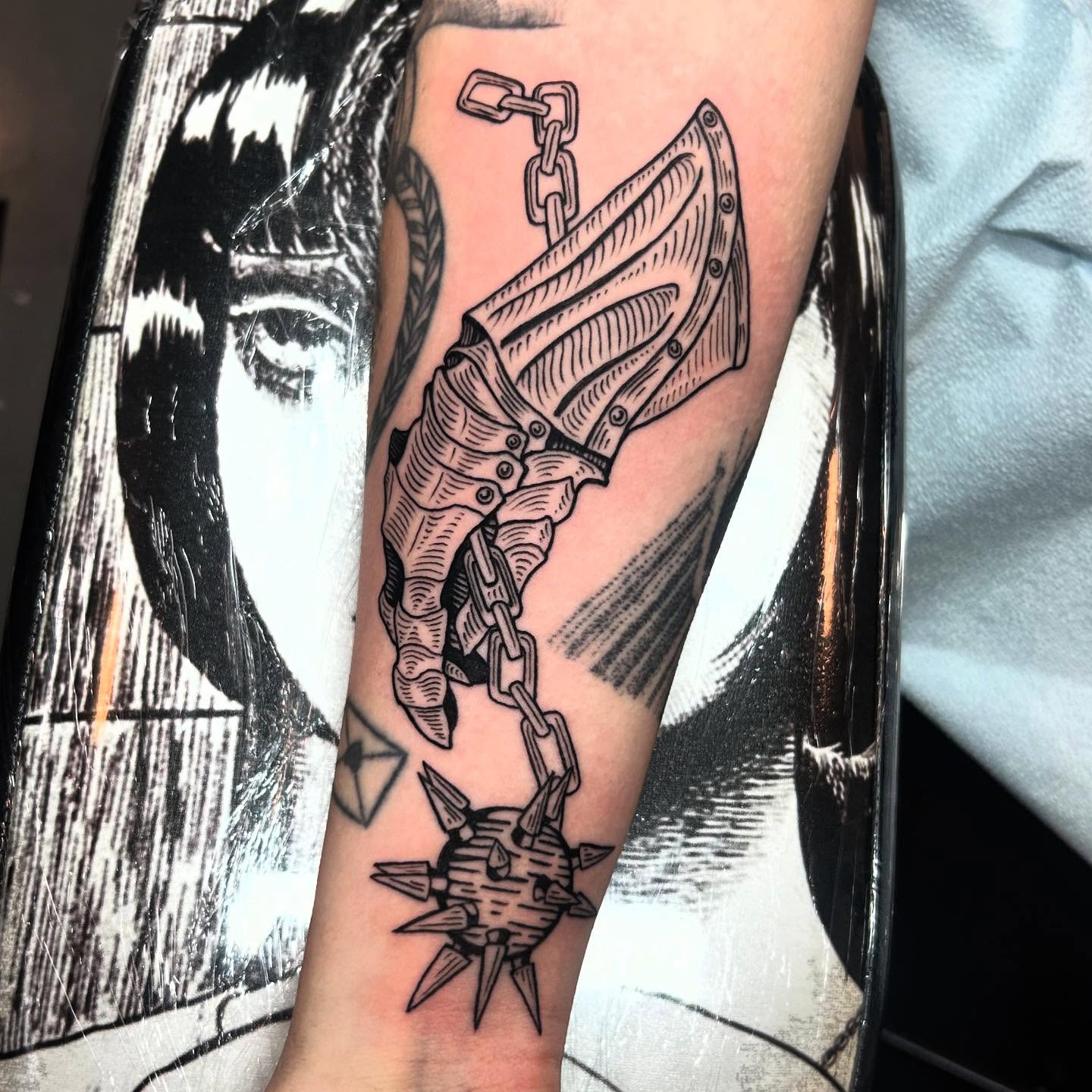 Anchor and chain black and grey tattoo on the forearm by Nikki Power